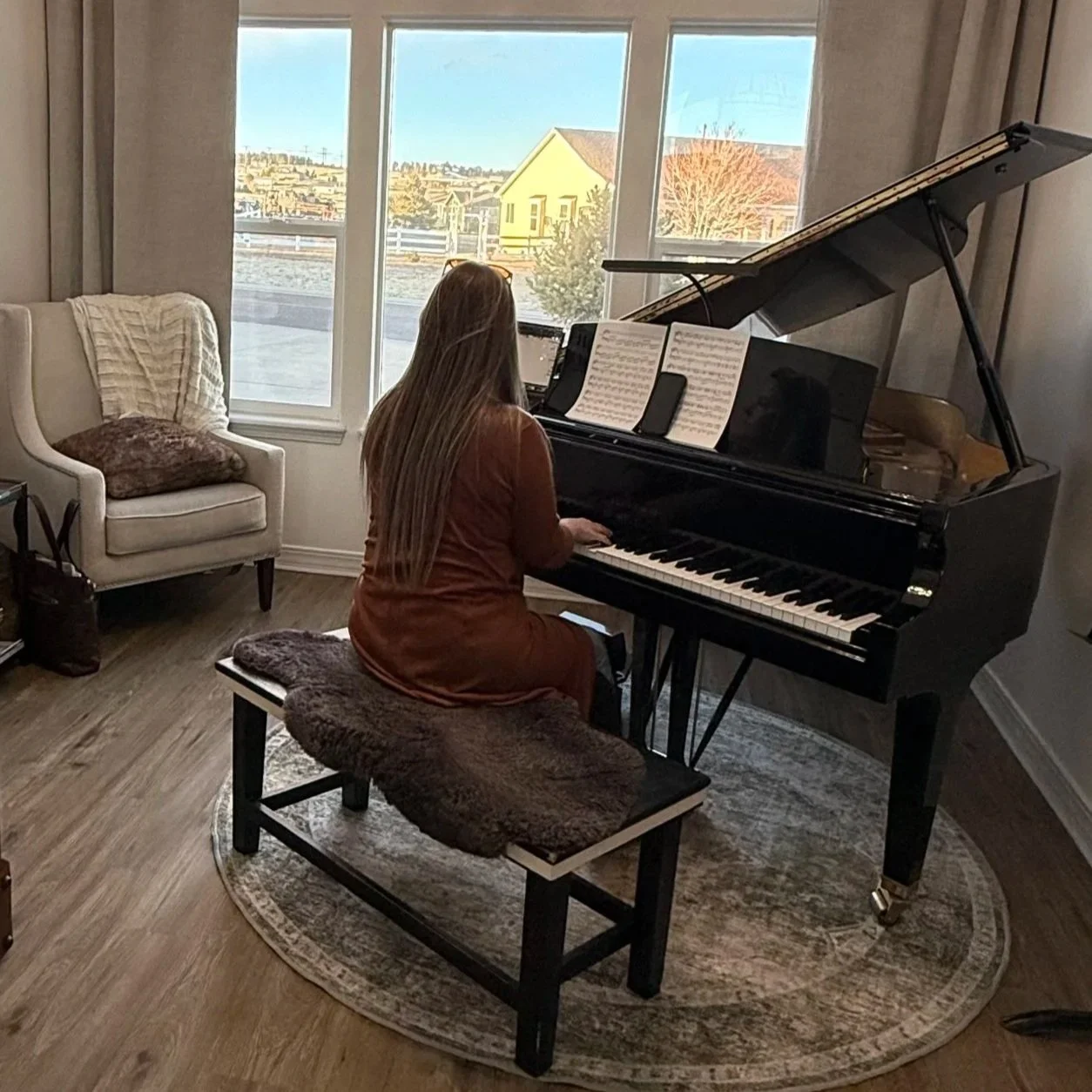 Brittany Brown practicing piano and preparing music in her home studio in Falcon, Colorado.