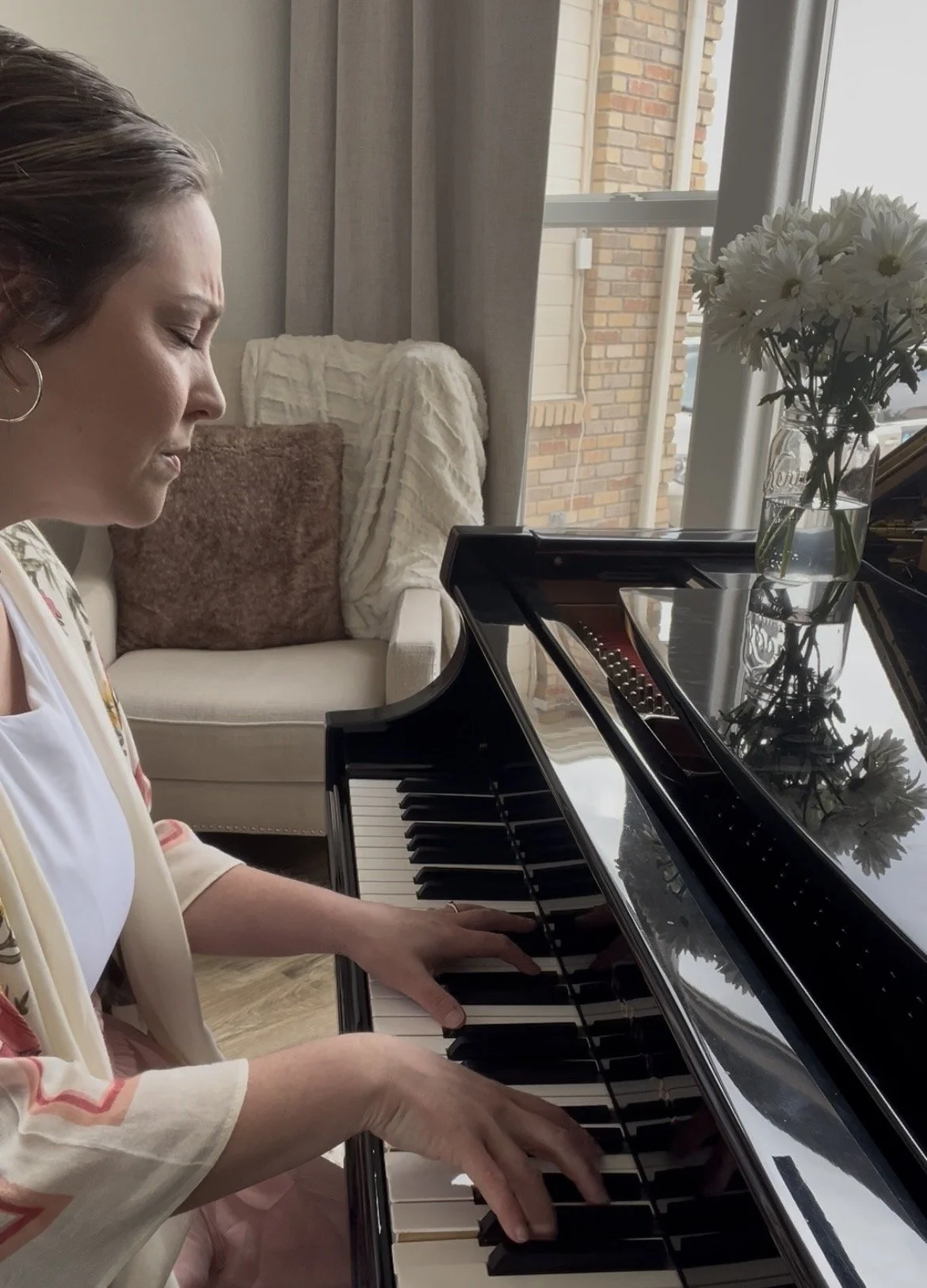 Brittany Brown practicing piano and exploring musical expression in her home studio.