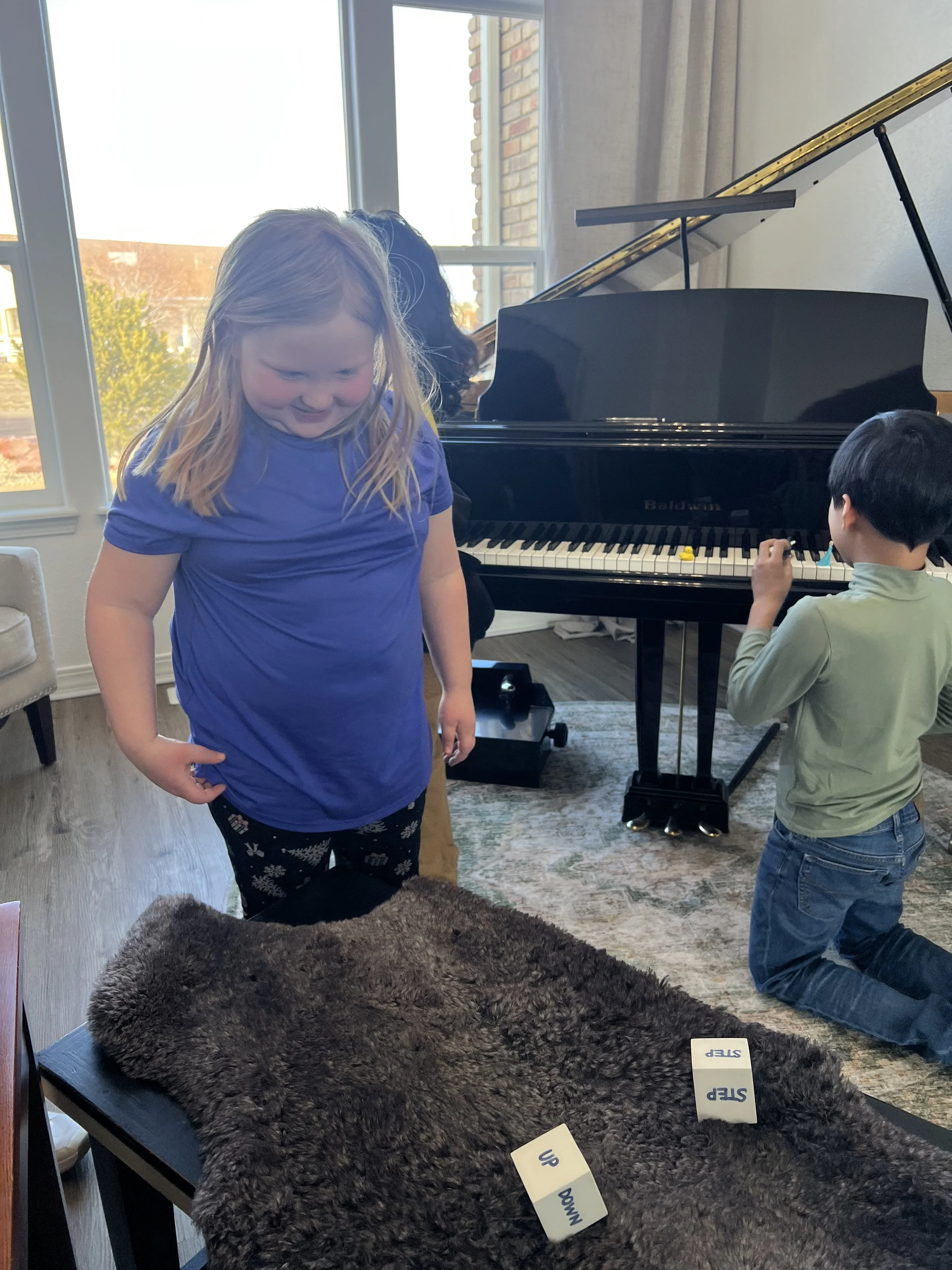 Students engaged in an interactive music lesson with piano games and activities.