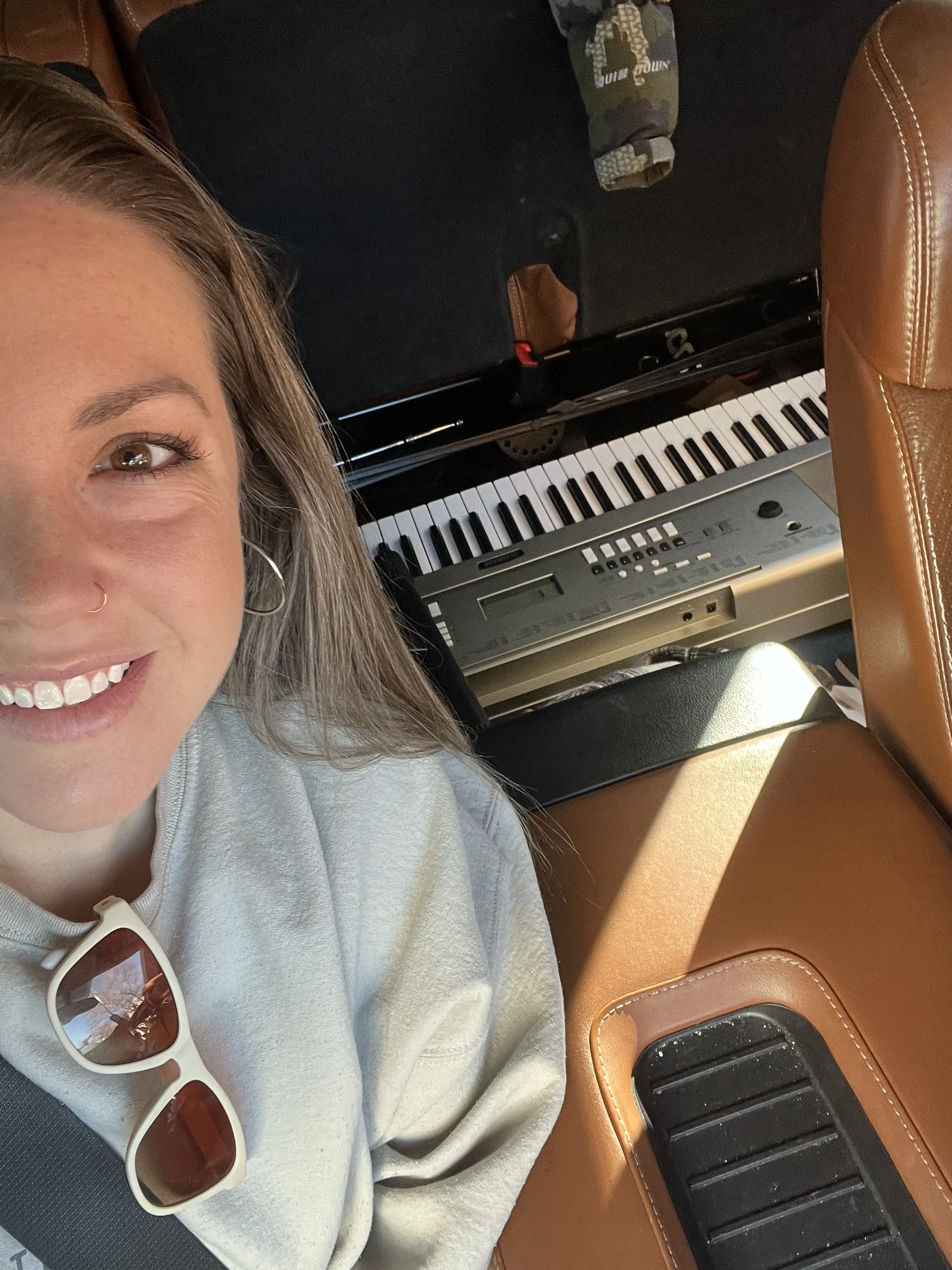 Brittany Brown building a piano lab and preparing keyboards for after-school group music classes.