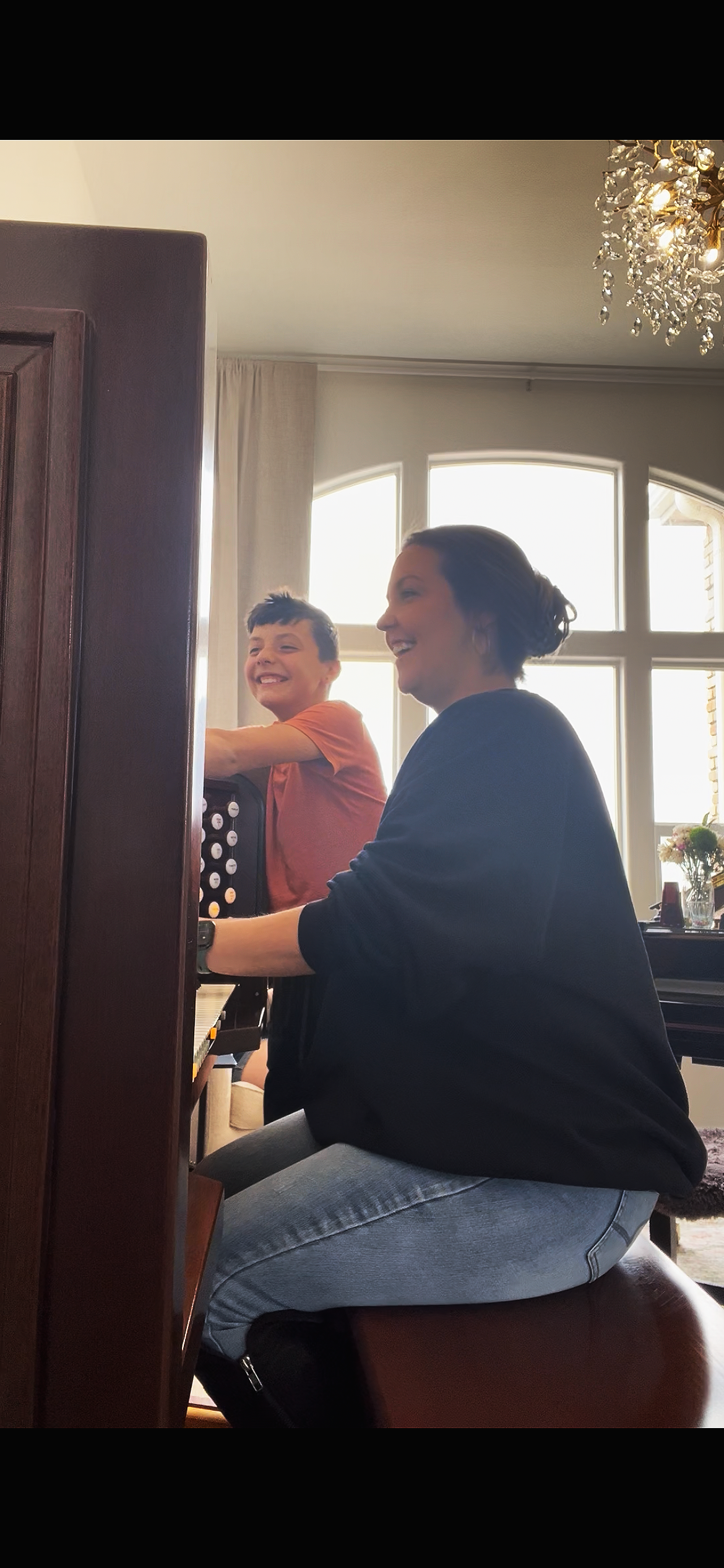 Brittany Brown and her son exploring music together during organ practice at home.