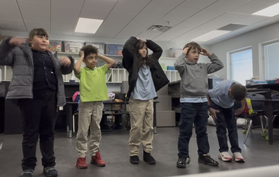 Students engaged in interactive music games and movement activities in group piano class.