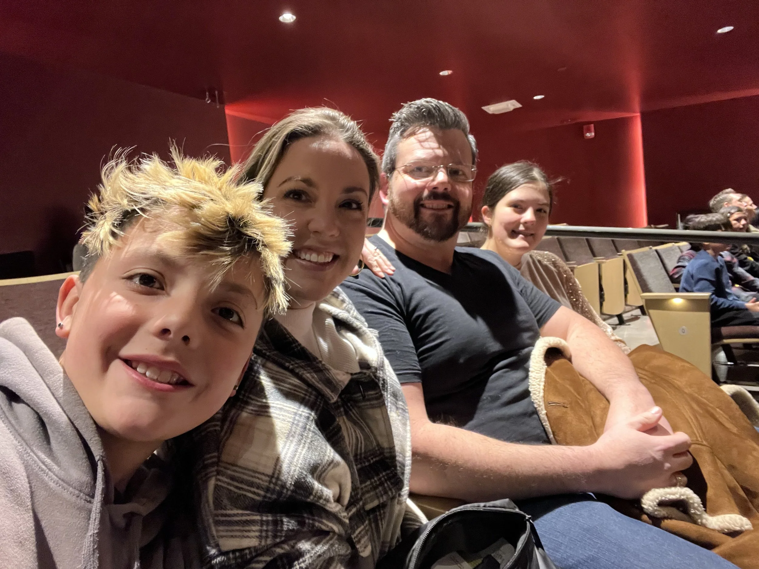 Brittany Brown attending a live musical performance with family and friends.