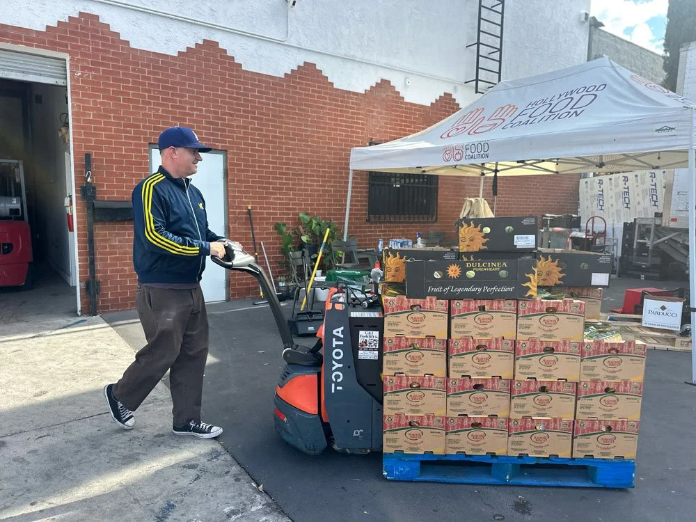 Man moving pallet of food