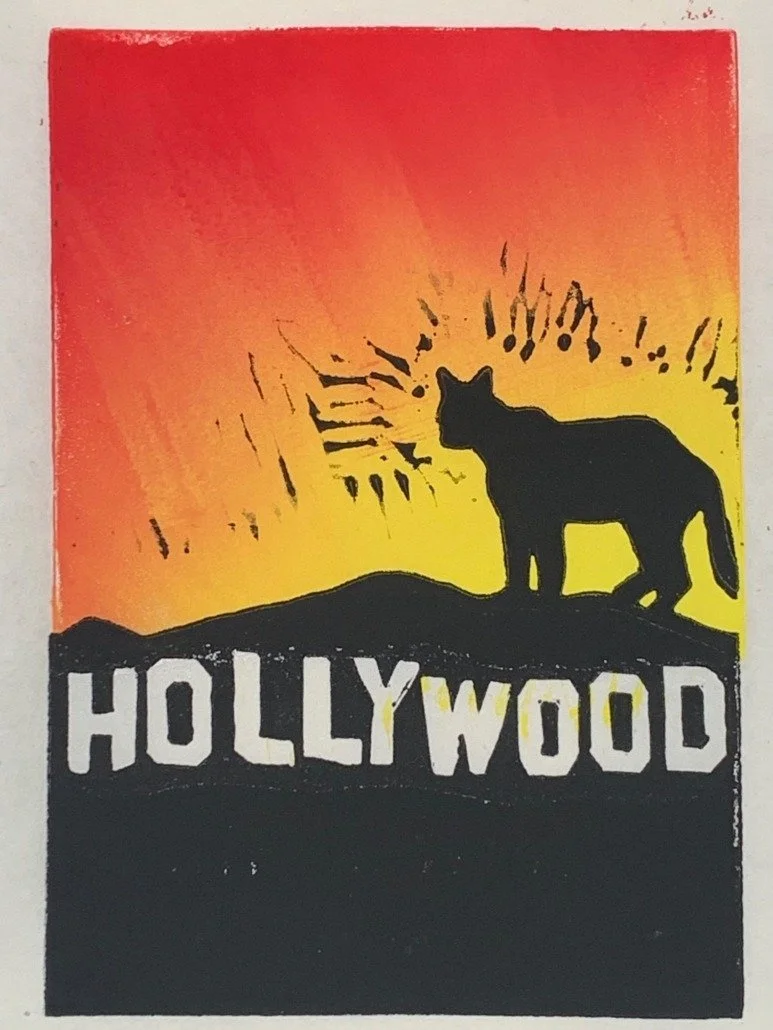 A black silhouette of a mountain lion in front of a sunset background with orange, yellow, and red hues. The silhouette includes the iconic Hollywood sign in California. The scene depicts a stylized, artistic representation of Hollywood.