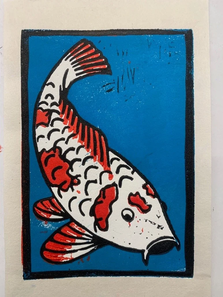 A stylized drawing of a koi fish with red, white, and black markings on a blue background.