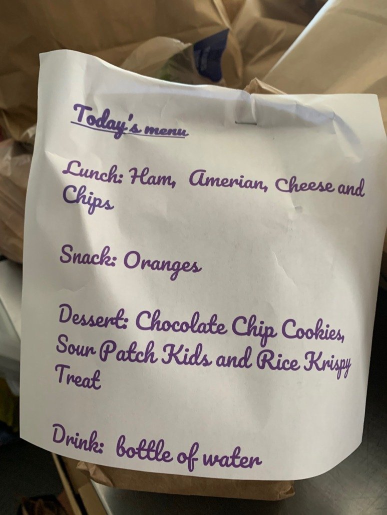 A paper menu listing today's meal options, including lunch, snack, dessert, and drink.