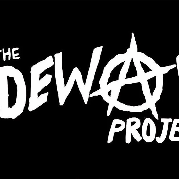 Black background with white text that reads 'The Dewalt Project' using a stylized font and an anarchy symbol incorporated into the word 'Dewalt'.