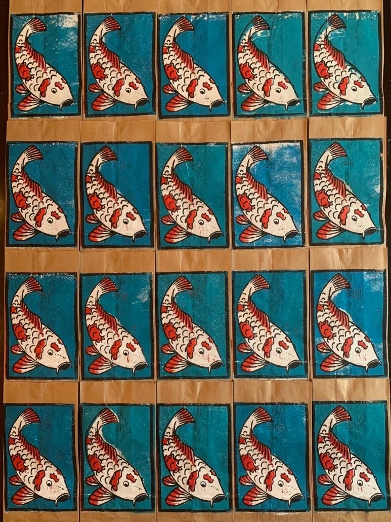 Artwork of 20 koi fish paintings arranged in a 4x5 grid, each fish on a blue background with red and white color details.