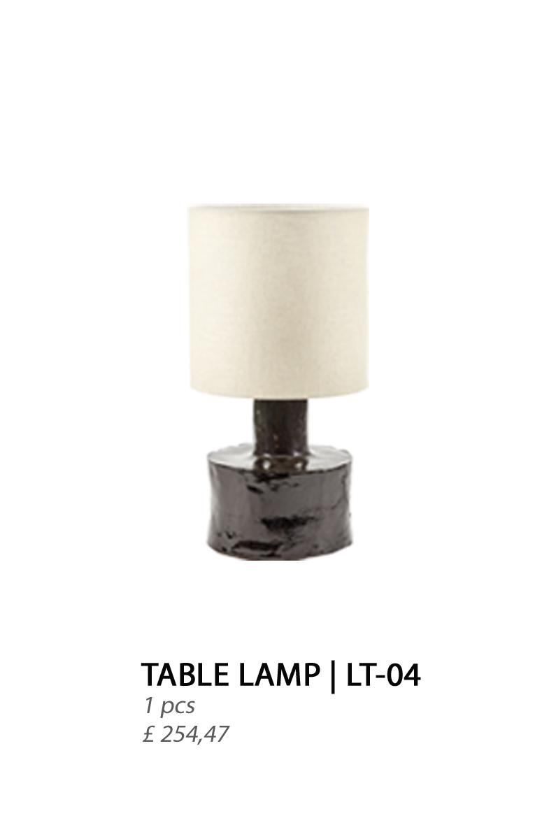 A table lamp with a creamy beige lampshade and a burgundy, glossy base.