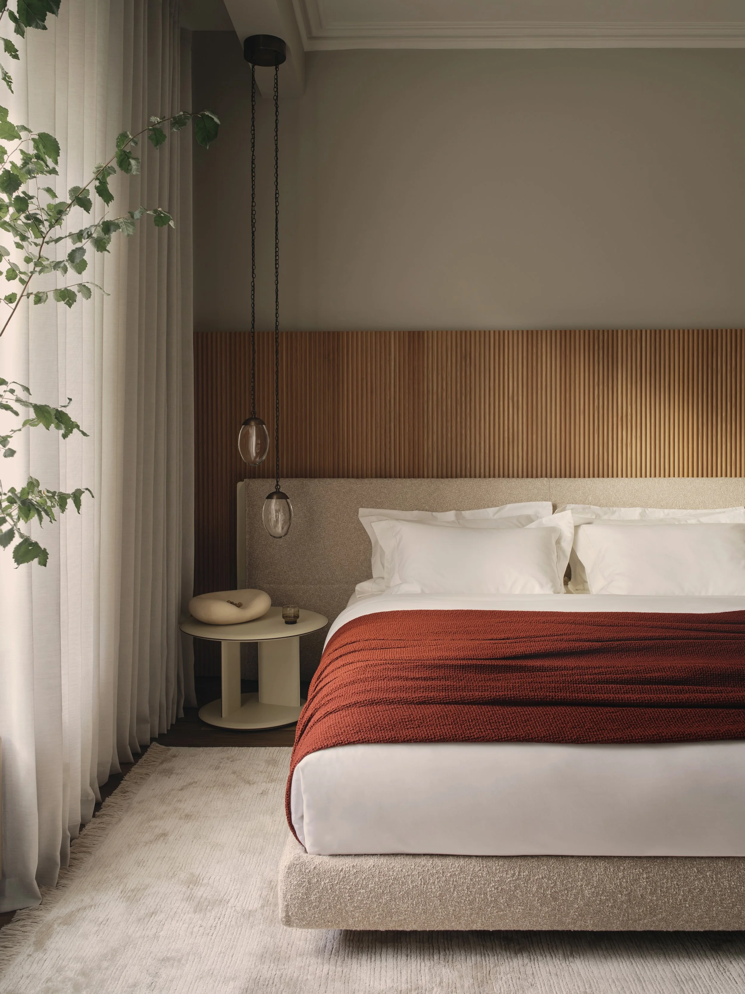 Bedroom interior design in Holland Park Residence by Jenny Ly Studio — calm neutral palette, tactile fabrics, and vertical oak paneling behind the bed.
