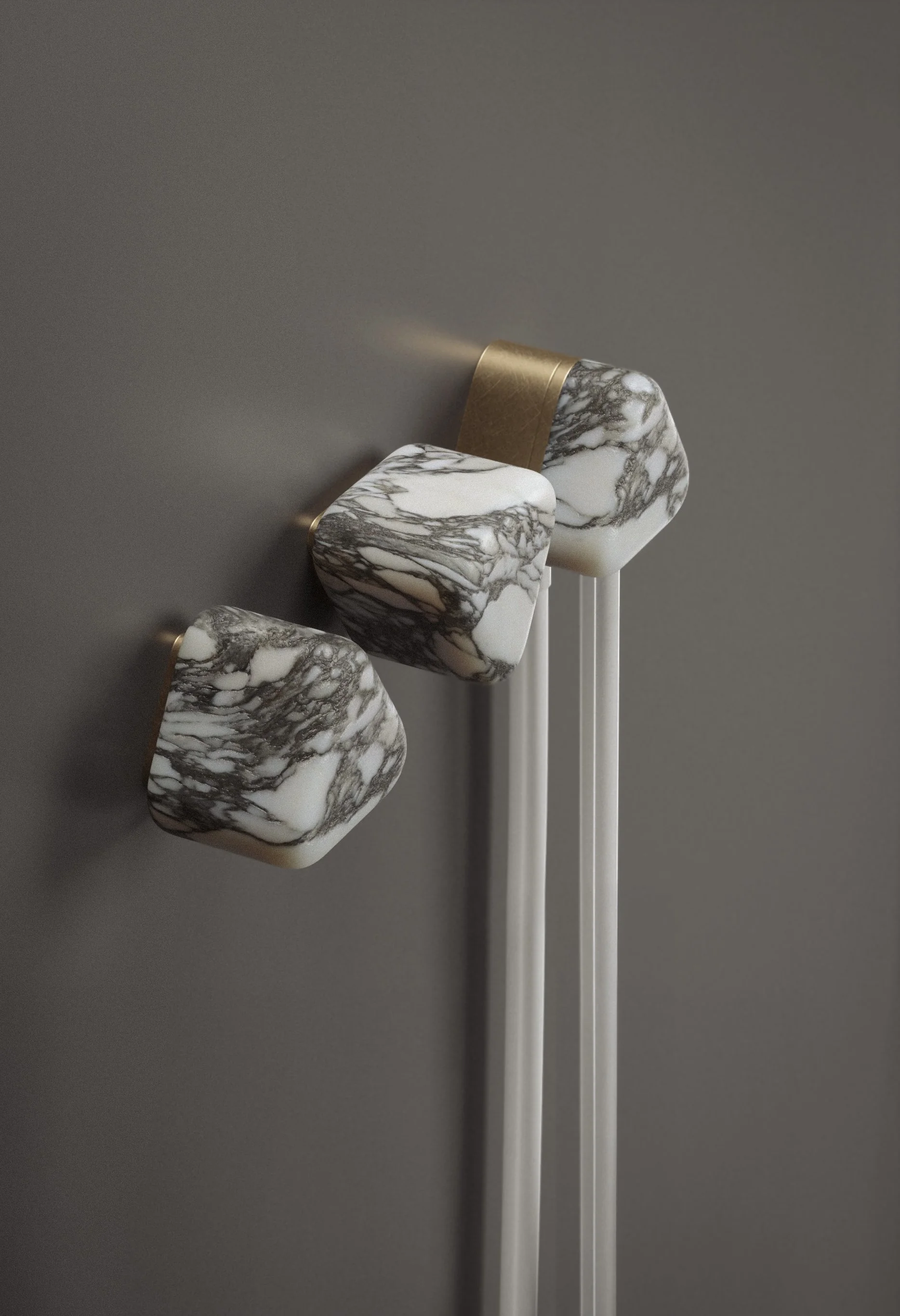 Wall-mounted marble and brass controls with hand shower from Trinity Collection by Jenny Ly Studio, designed to express balance, tactility, and material harmony.