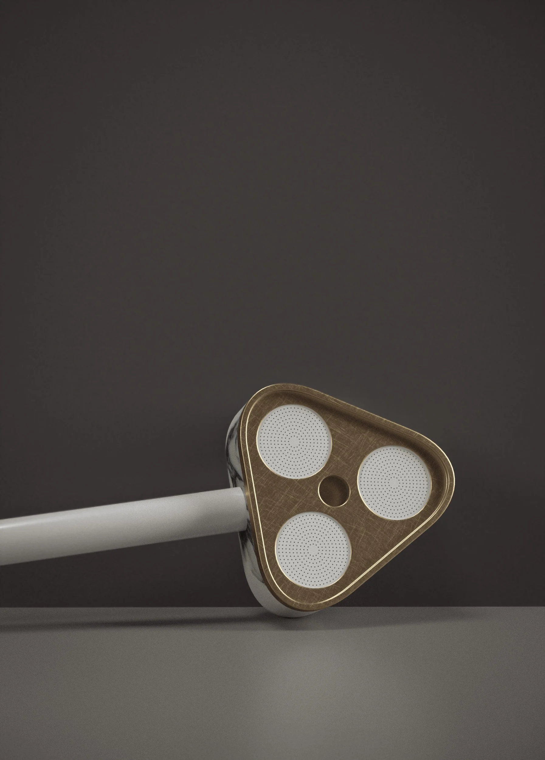 Triangular hand shower from Trinity Collection by Jenny Ly Studio, combining brushed brass detailing with a sculptural marble handle.