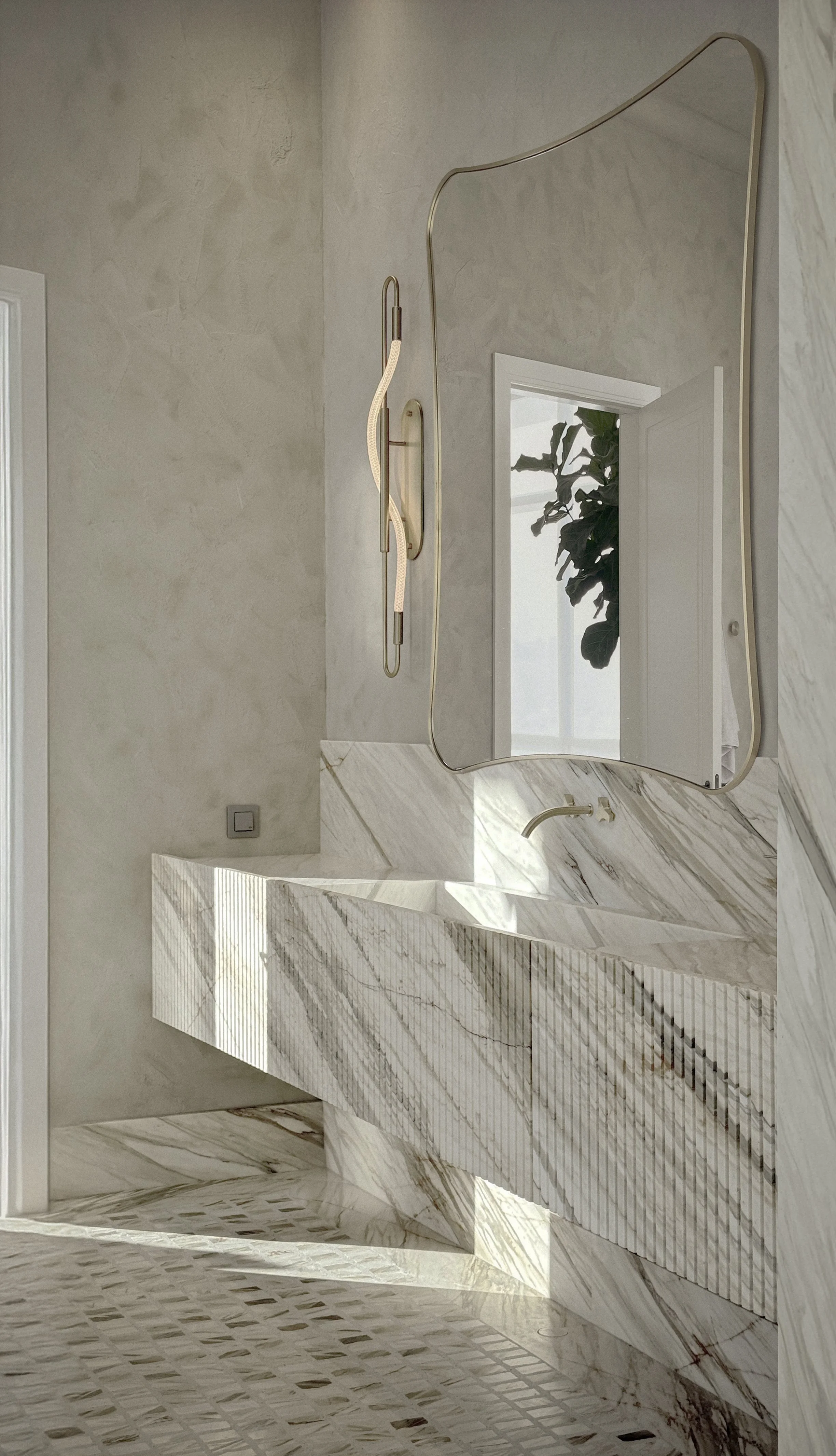 Marble bathroom interior of Kensington Penthouse by Jenny Ly Studio — honed stone sink, soft plaster walls, and sculptural lighting