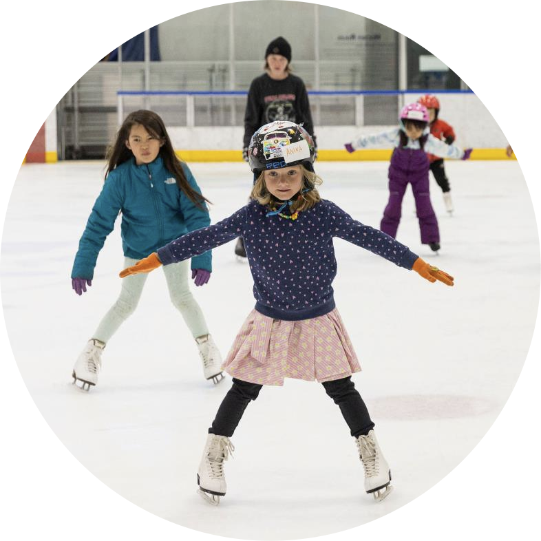 Three children in a beginning skating class