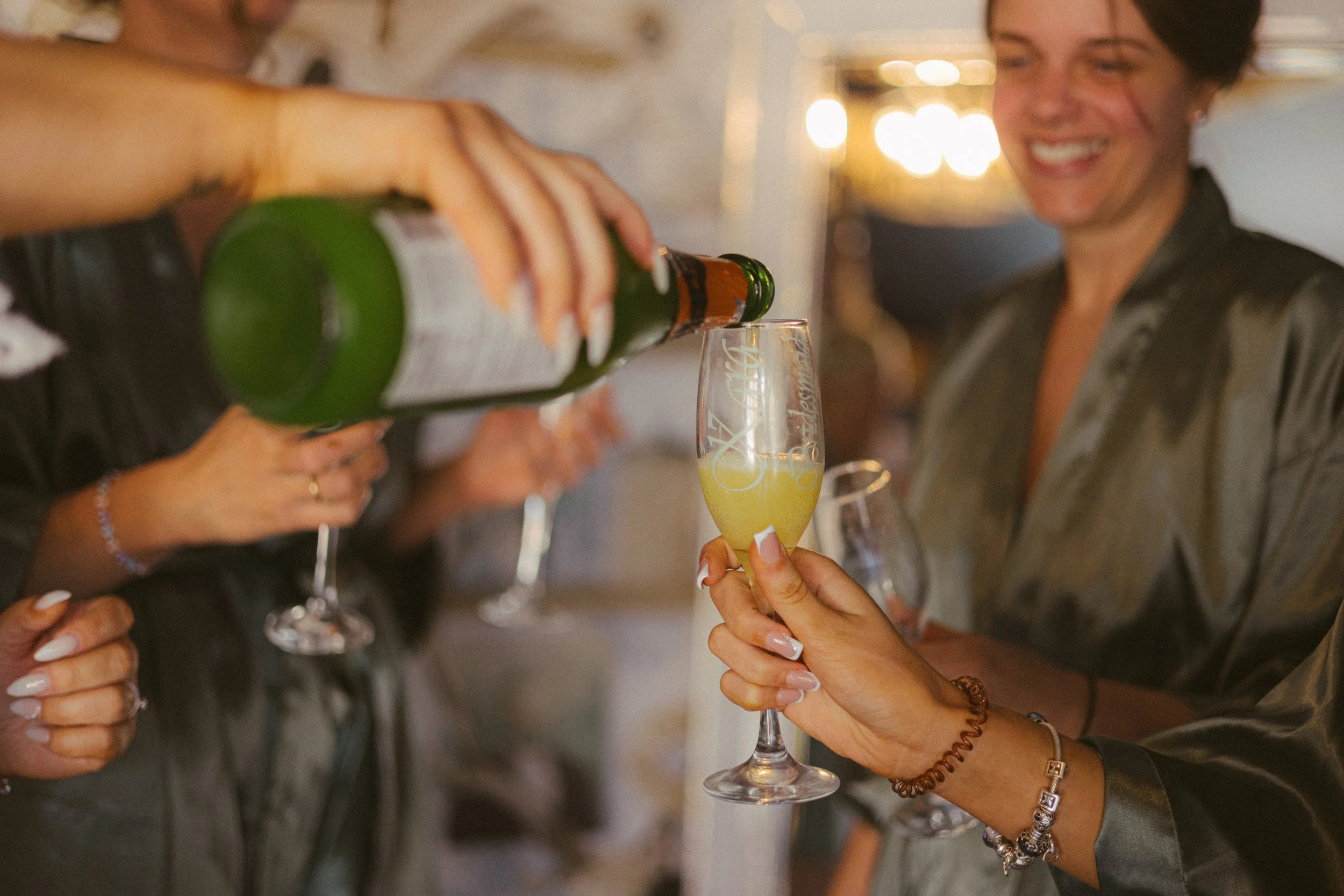 People celebrating and toasting with glasses of champagne or sparkling wine at a party or gathering.