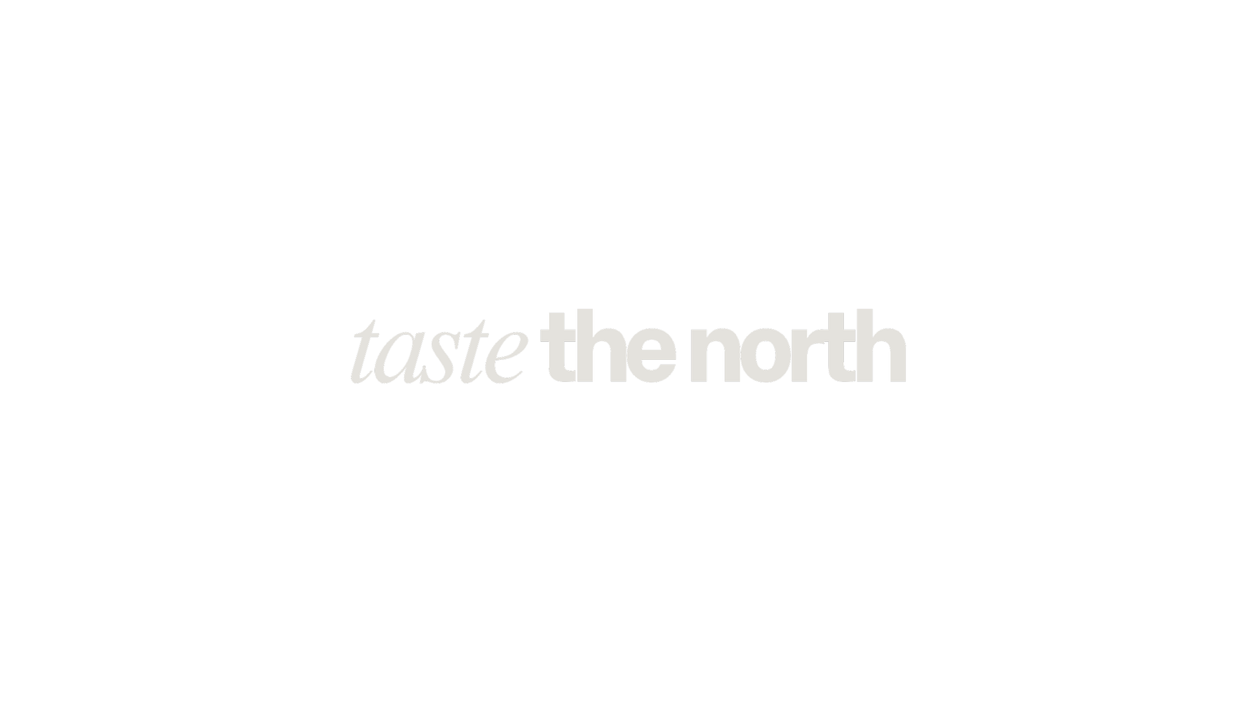 Black background with the words 'taste the north' in gray and white text, with 'taste' in italic and 'the north' in bold.