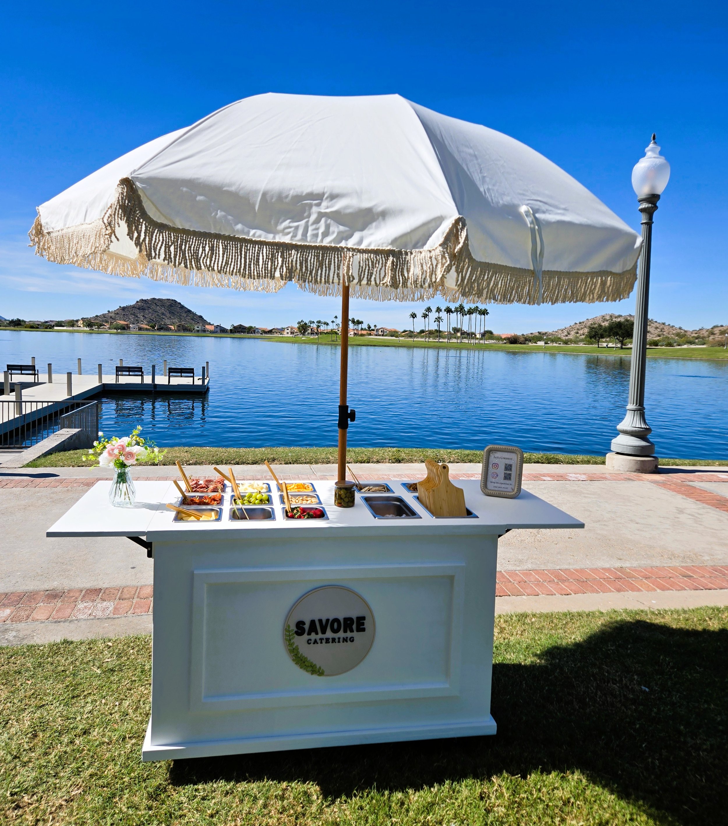 Charcuterie cart displayed for a wedding where people are serve mini charcuterie boards.