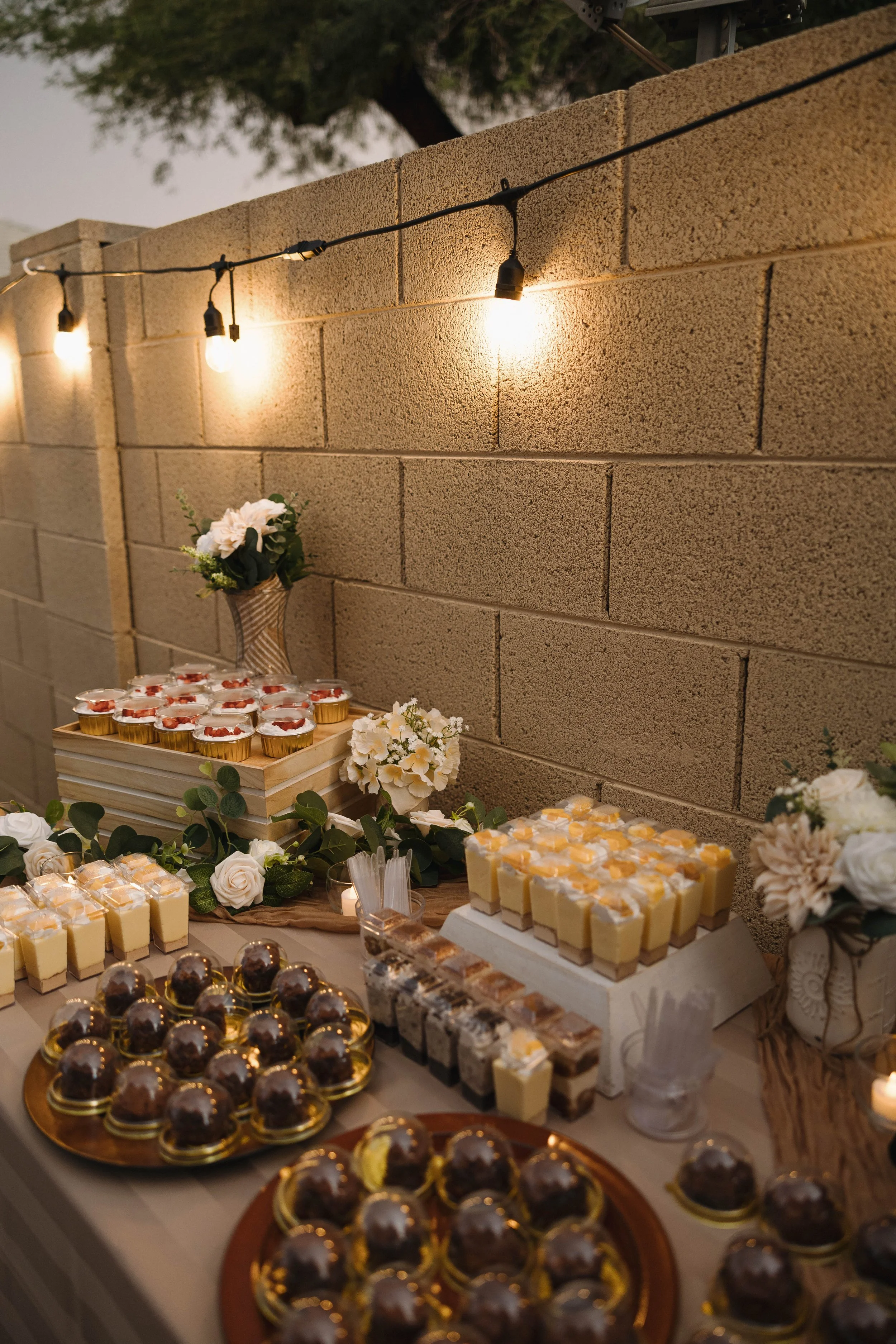 Phoenix dessert table with mini cheesecakes and cupcakes.
