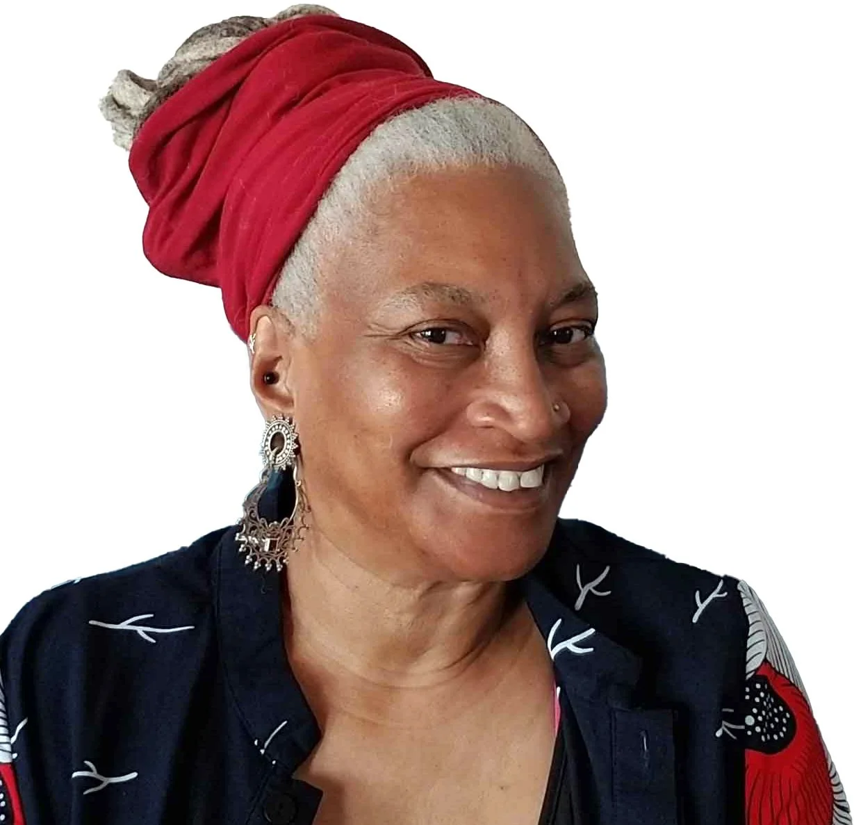 A smiling woman with a red headscarf, earrings, and dark clothing on a white background.