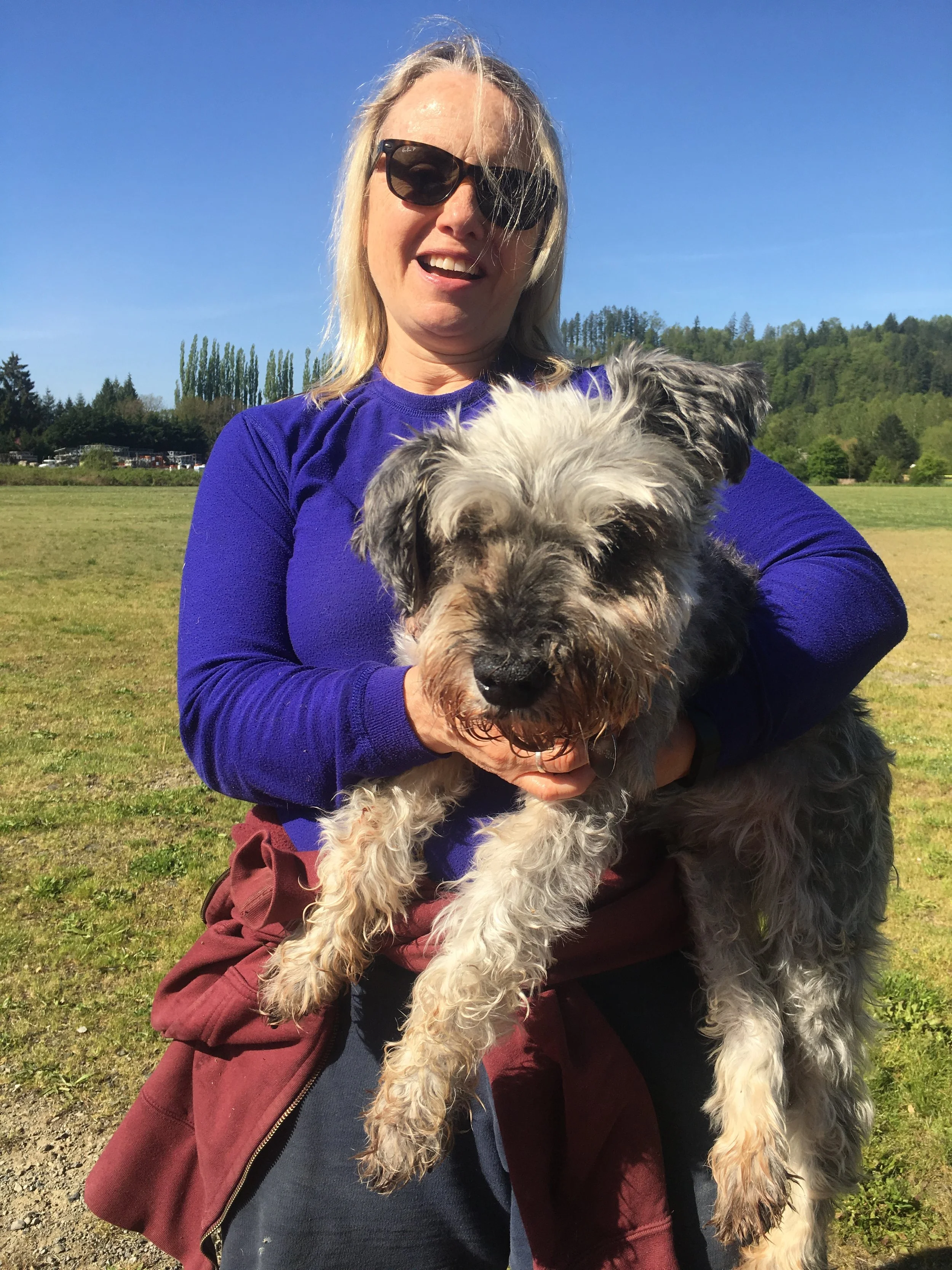 A picture of the founder of Fall City Dog Boarding and her dog