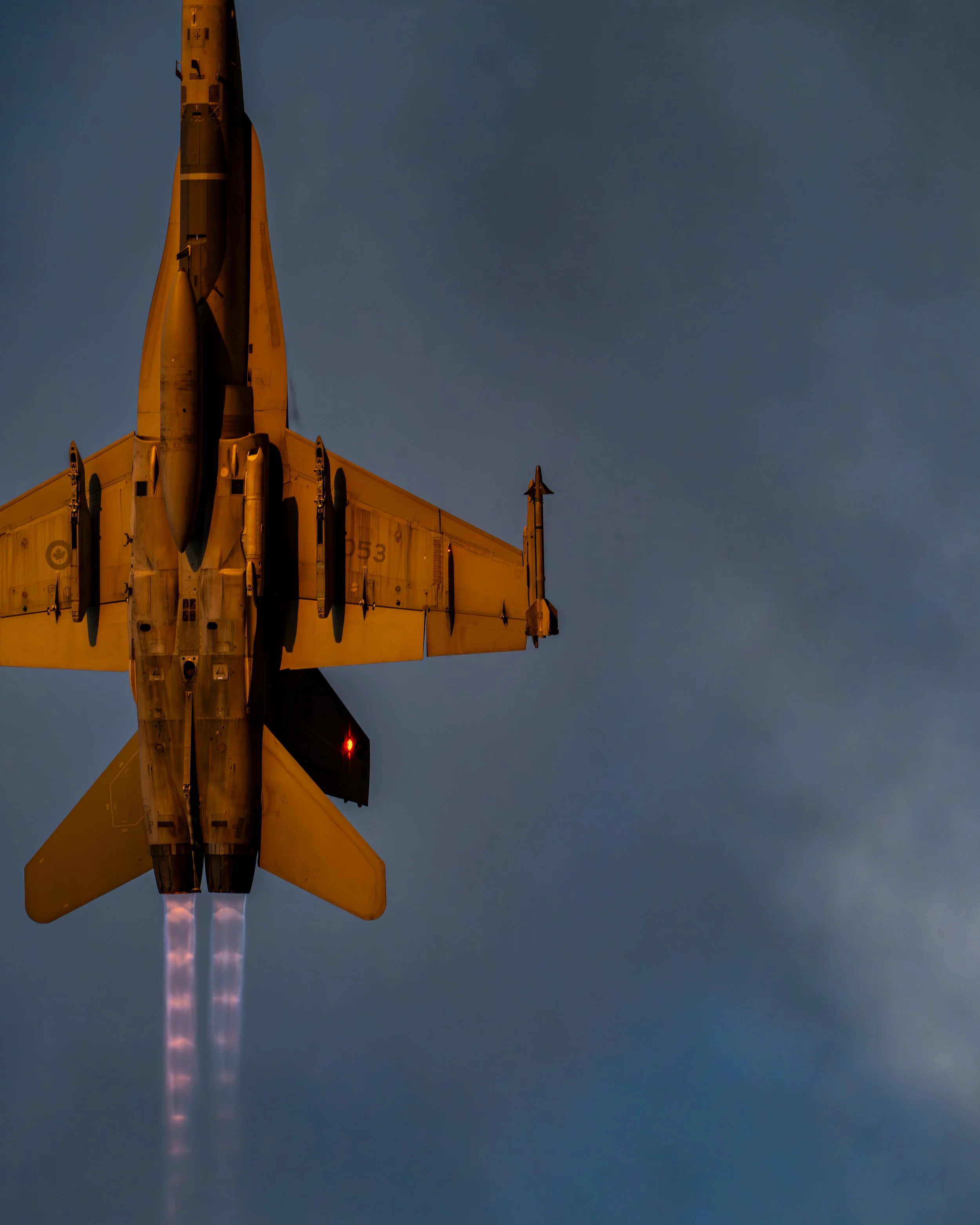 A Royal Canadian Air Force (RCAF) CF-188A (188053) Hornet flying during the Abbotsford Airshow at Abbotsford International Airport (YXX) during the Friday twilight show.