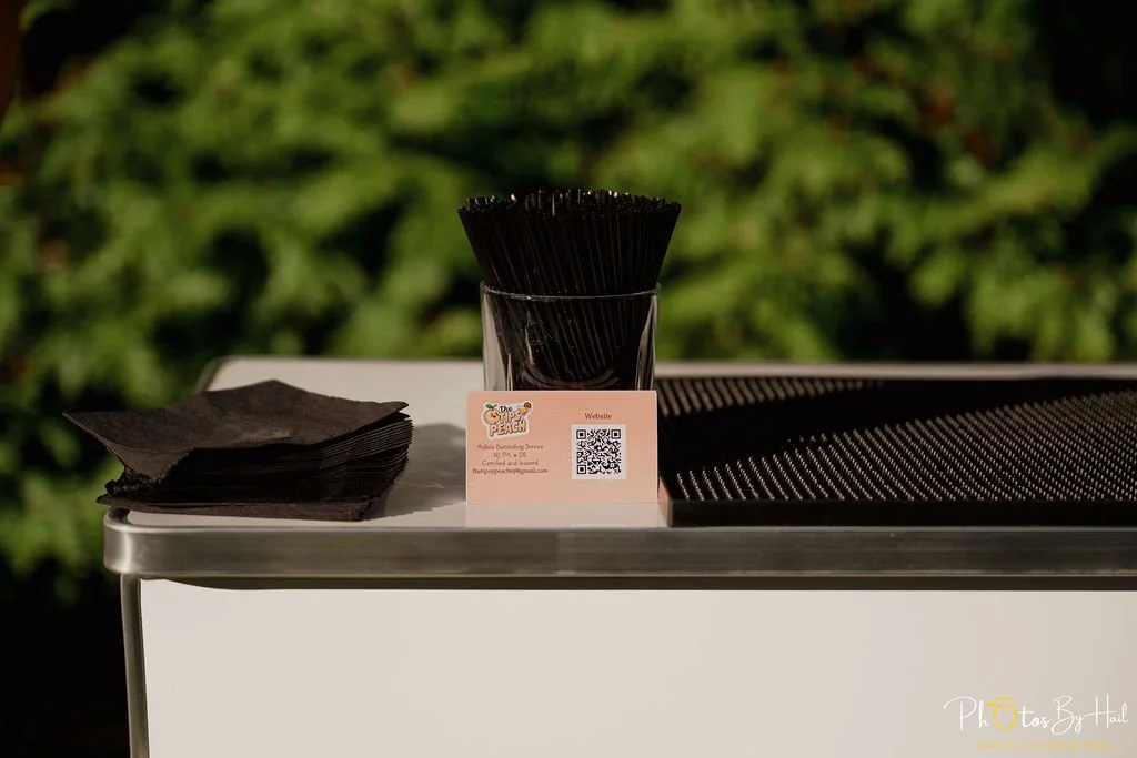 napkins, bar straws, and business card displayed on satellite bar