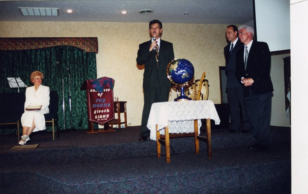 Carol, left, watches John preach, middle, during a service at Christ Community Church.