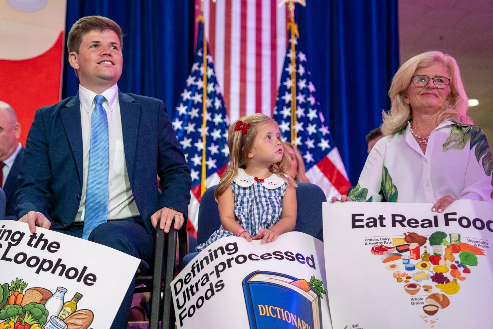A child holds a sign during a Health and Human Services event to celebrate “improving the nation's food supply and advance the Make America Healthy Again agenda” at the U.S. Department of Health and Human Services  in Washington, D.C., on Monday, Aug