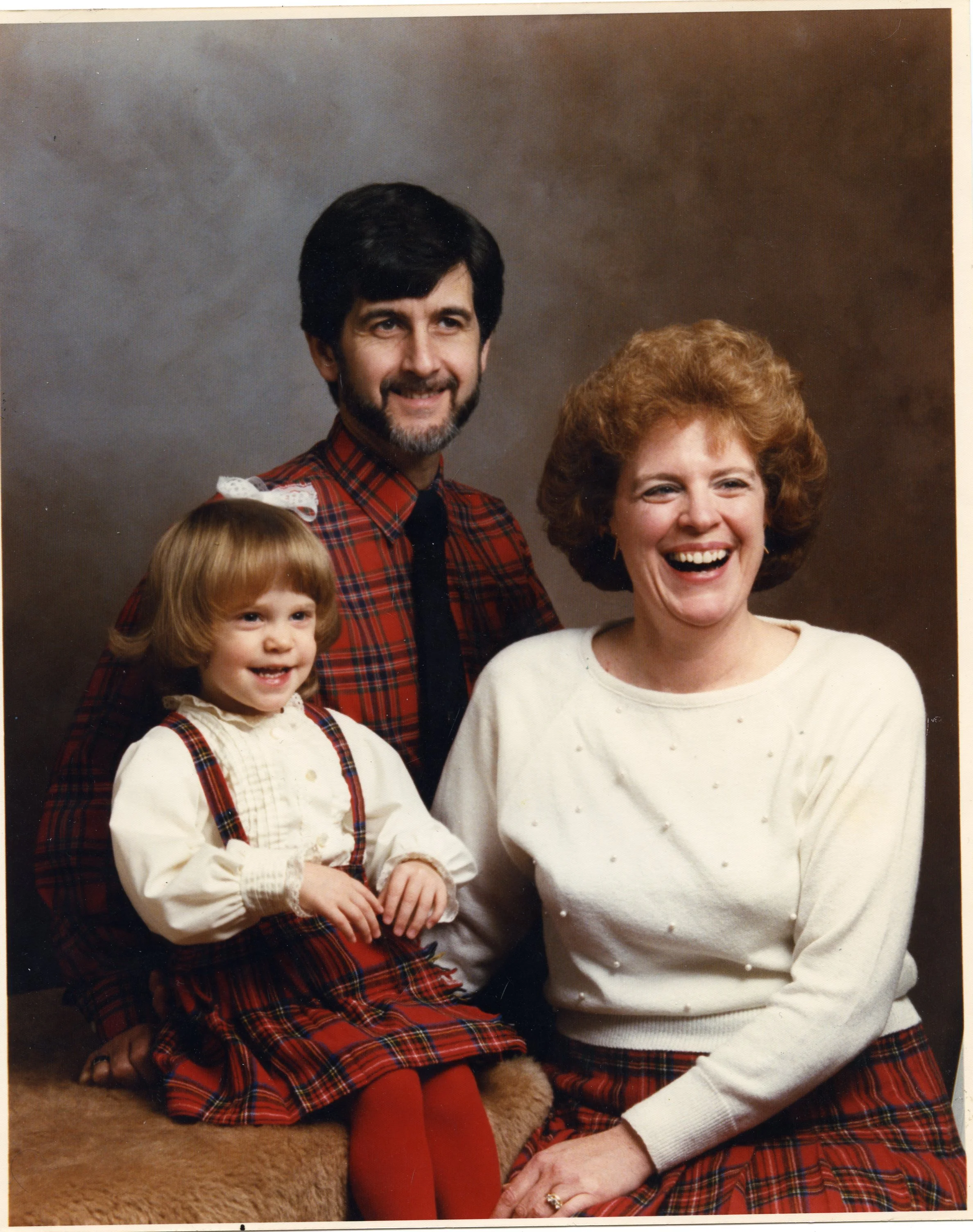 John, Meg, and Carol sit for a family portrait.