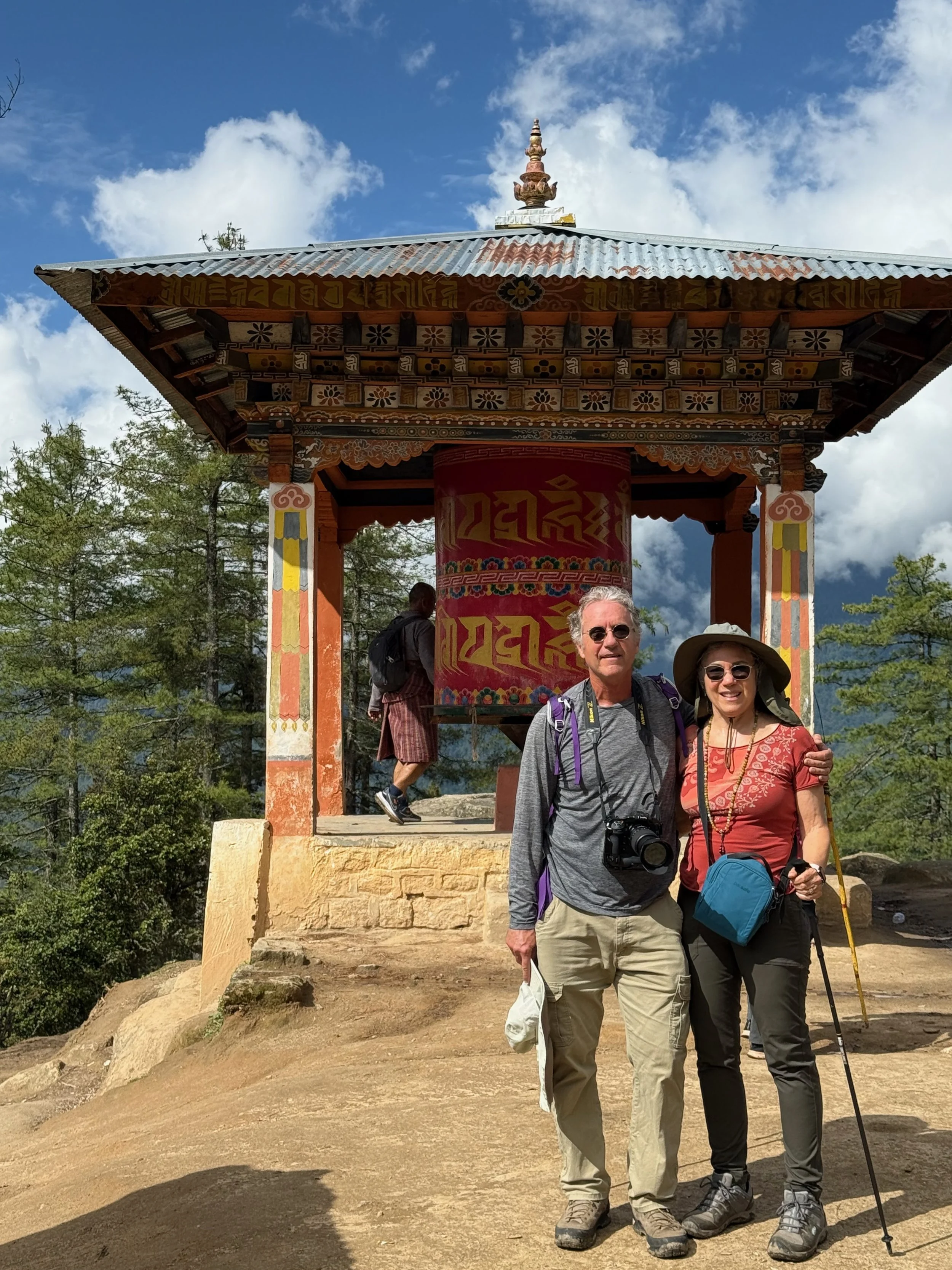 Barry and Laura by prayer wheel walking to Tiger's Nest in Bhutan