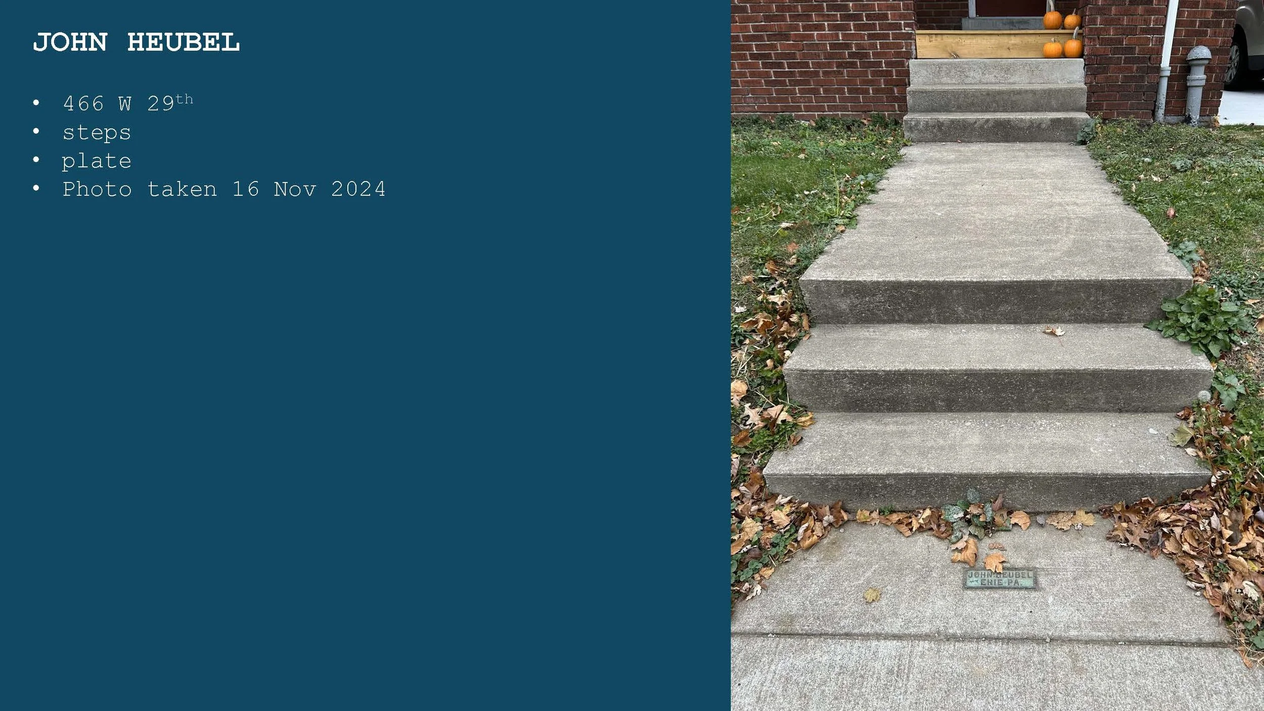 Photograph of a concrete step staircase leading up to a house with pumpkins on the porch. The photo is taken from ground level looking up.