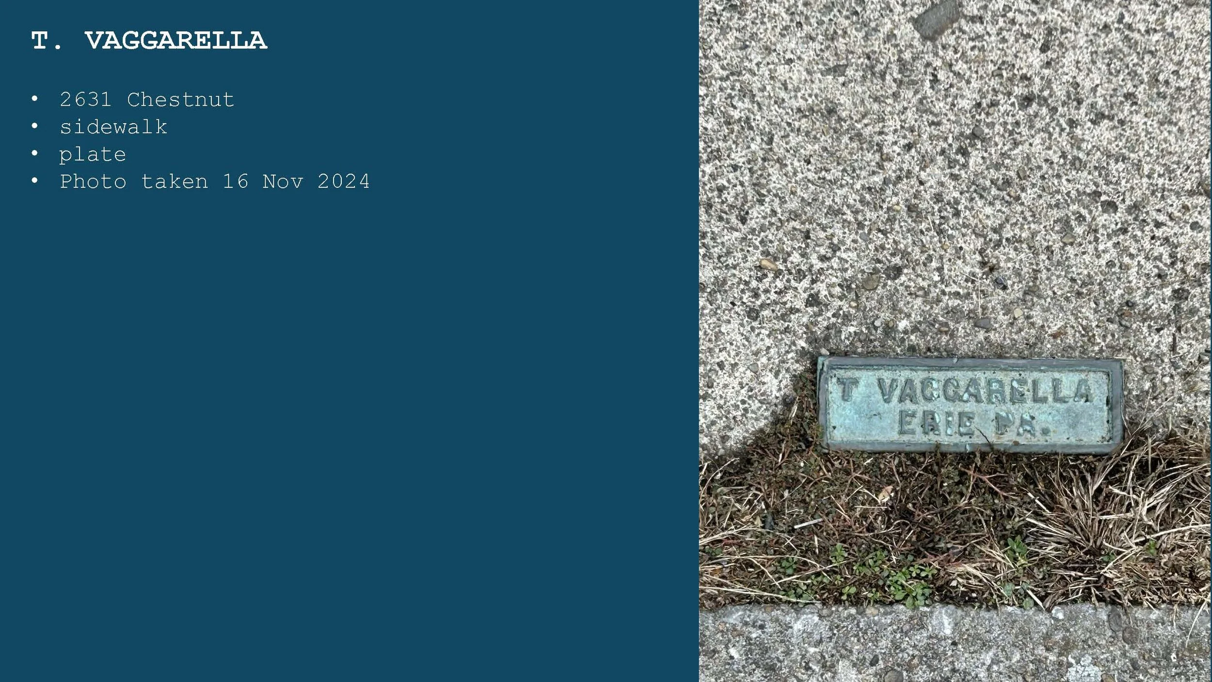 A sidewalk with a cast iron plaque embedded in the ground that reads "T VAGGARELLA ERE D." The sidewalk is concrete with some grass and small plants growing around the plaque.
