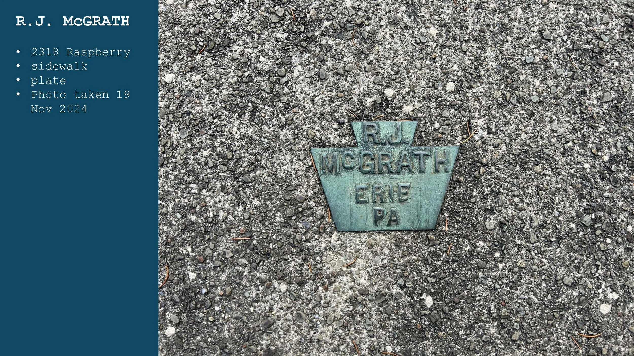 Close-up of a metal marker on a gravel sidewalk, engraved with the words 'R.J. McGRATH Erie PA', with some pine needle debris.