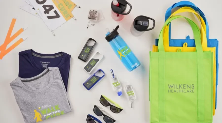 Sports and healthcare items on a white surface, including towels, sunglasses, water bottles, blood glucose meters, insulin pens, and reusable tote bags.