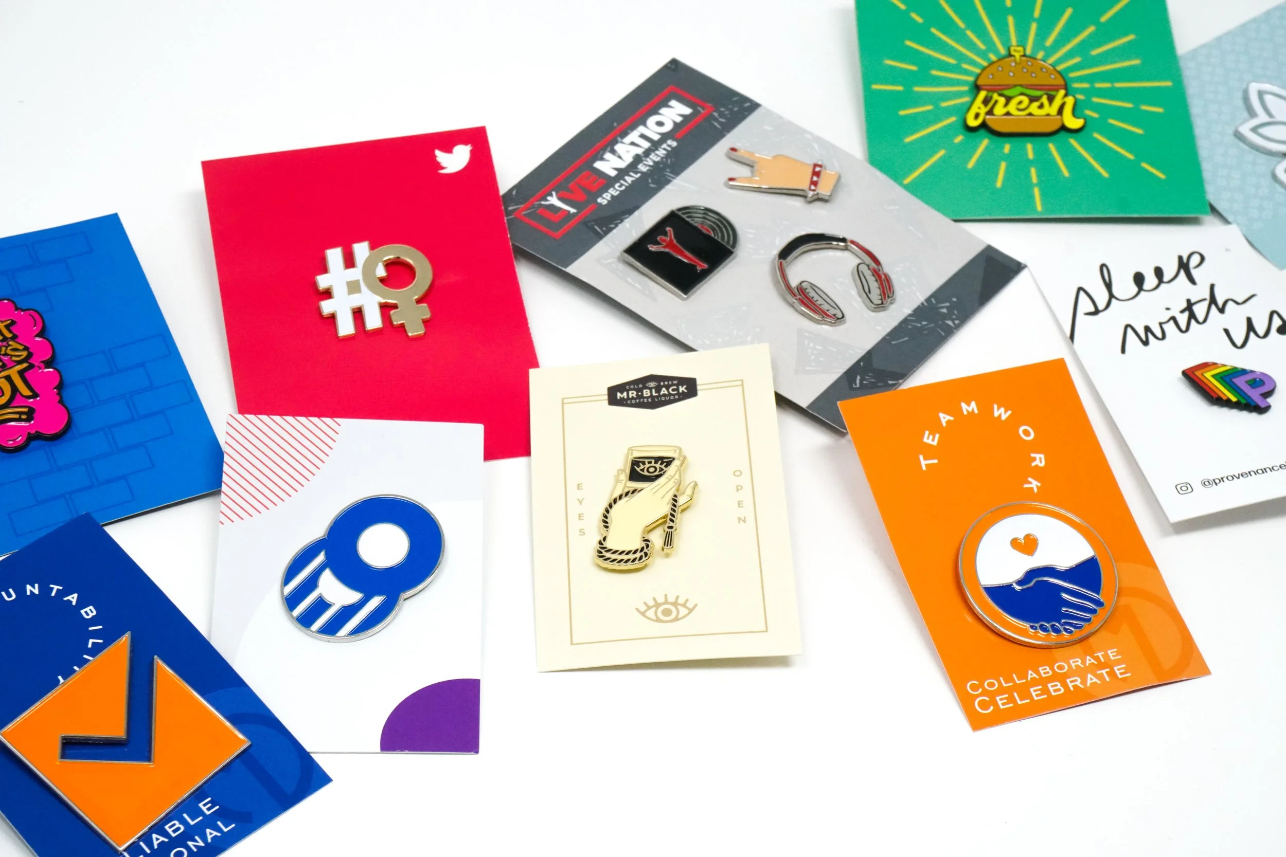 Collection of colorful enamel pins and badges on various cards and backgrounds