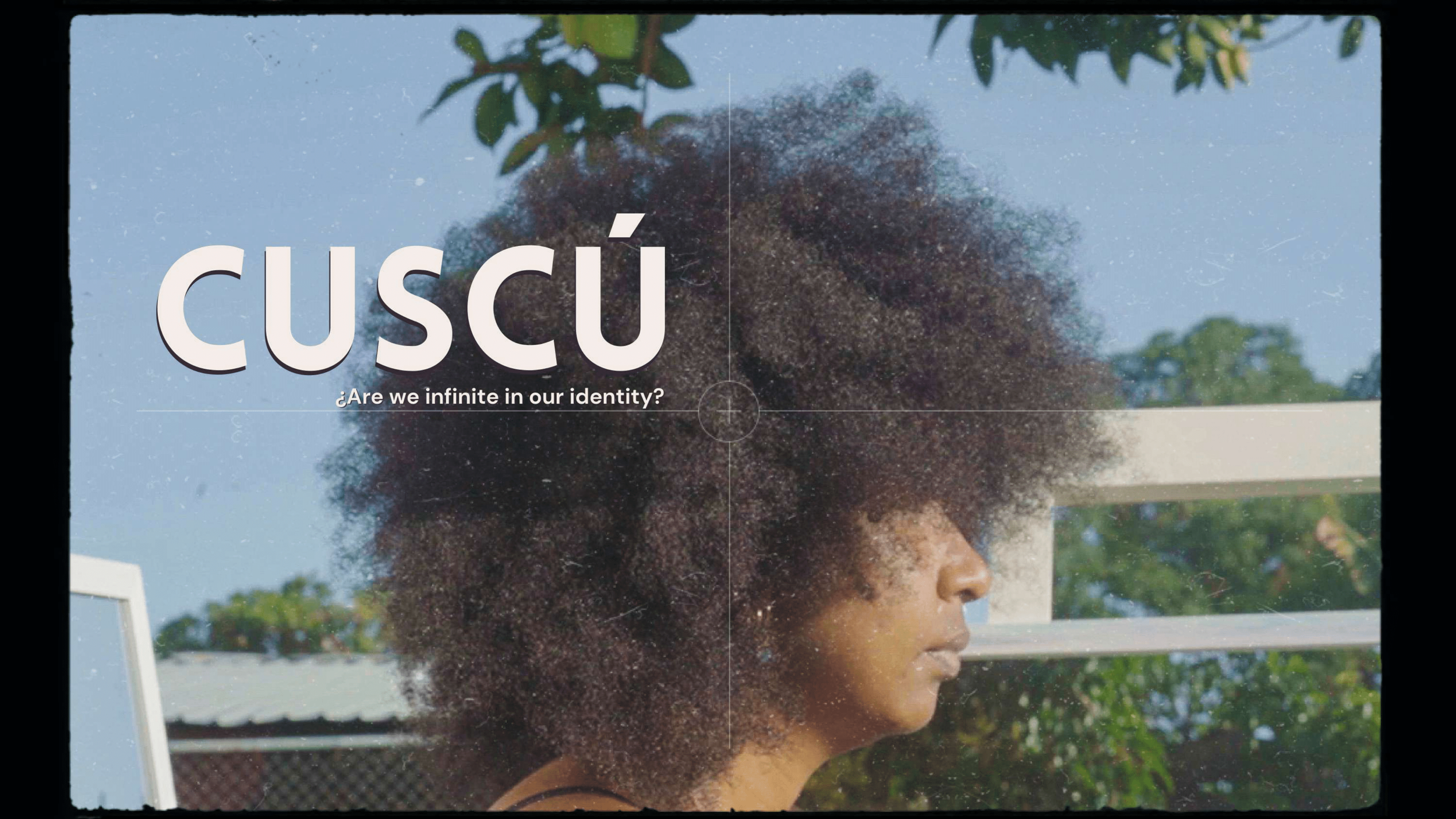 A Panamanian woman with a large, curly afro hairstyle in profile against a background of trees and a building, with the word 'cuscú' and a question about identity overlaying her face.