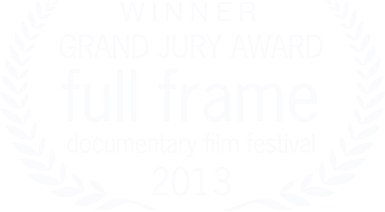 Award badge with text indicating winner of the Grand Jury Award for full frame documentary film festival in 2013, surrounded by a laurel wreath.