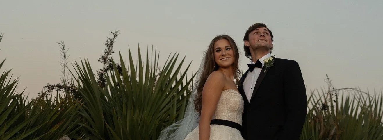 Newlyweds celebrating after the ceremony at The Velveteen wedding venue in Madison, MS, bride in beaded gown with groom in classic tuxedo.