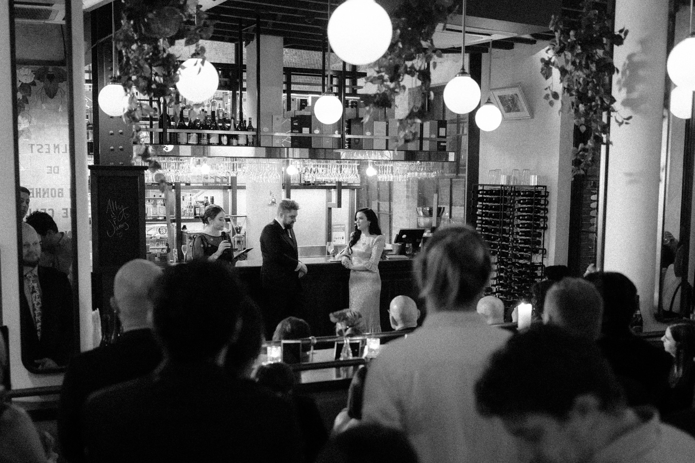 Couple leaning against the bar during wedding ceremony at Gavroche Restaurant