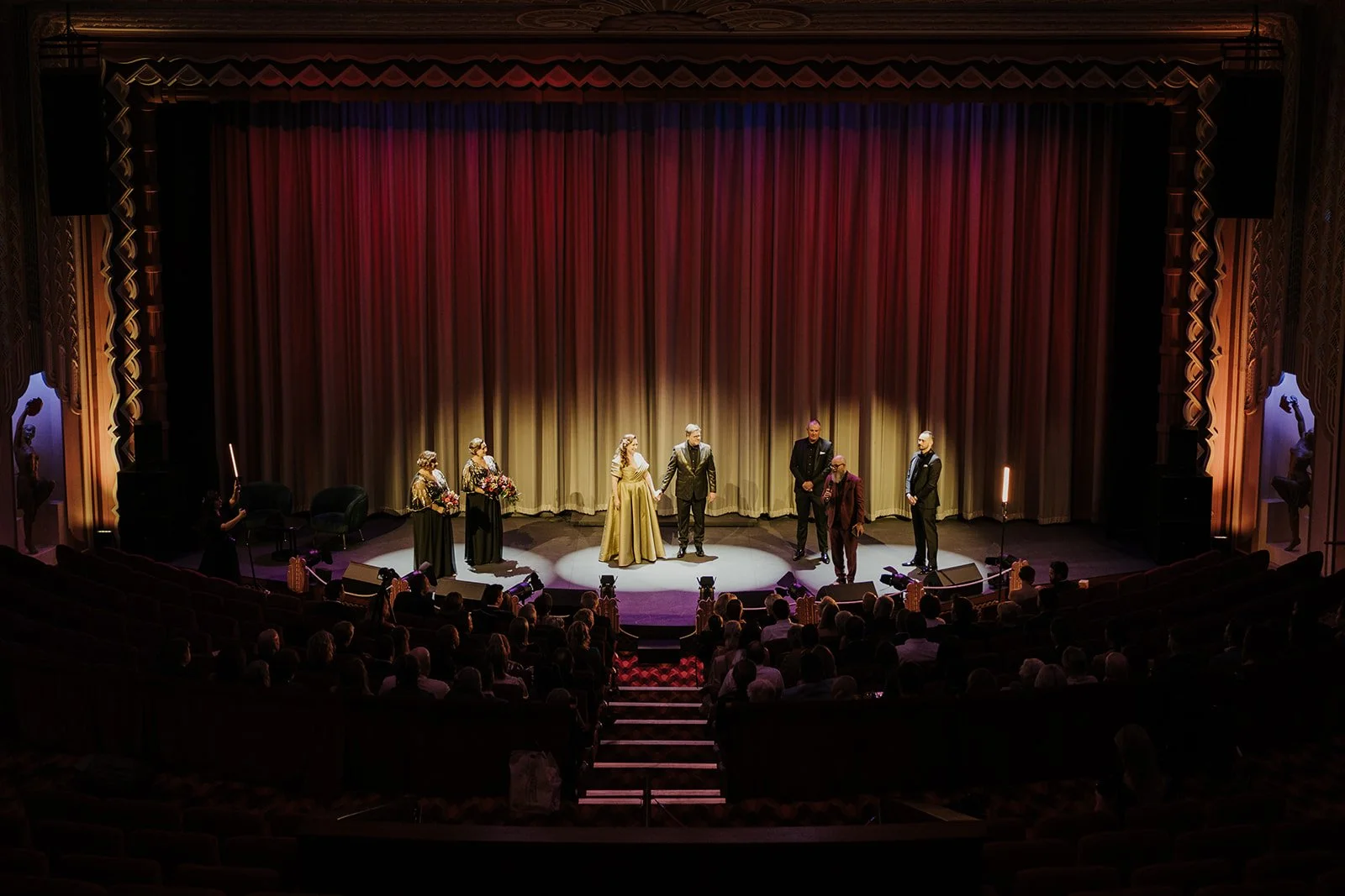 Bride and groom getting married on stage at Hayden Orpheum