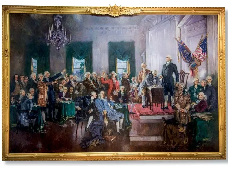 An historic painting of a formal 18th-century American political meeting with delegates seated and standing, with American flags in the background.