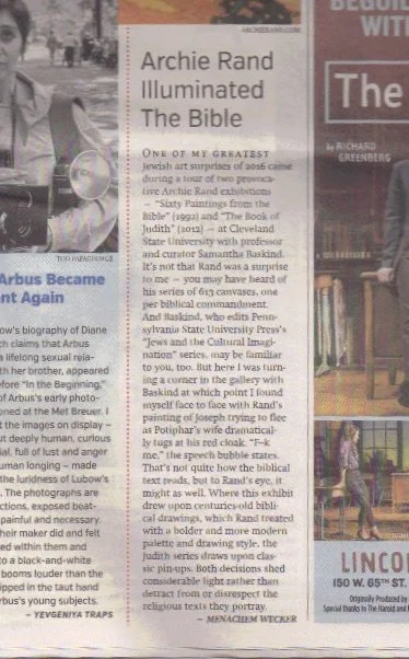 A page from a magazine or newspaper with an article about Archie Rand's biblical art, including a partially visible red and white advertisement and an image of a woman in a dress.