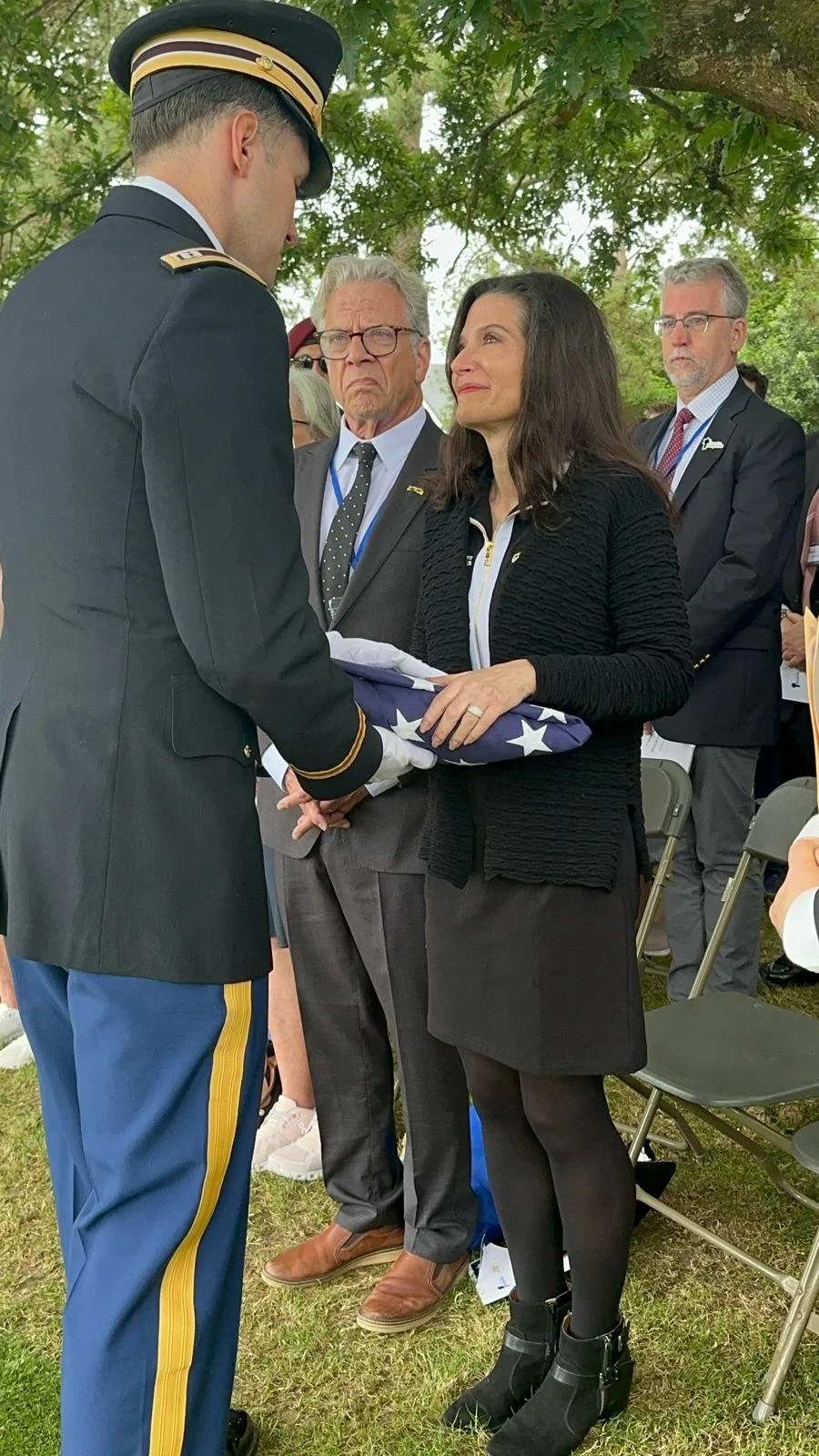 Samantha Baskind receives a folded American flag from the military during a memorial for Nathan Baskind.