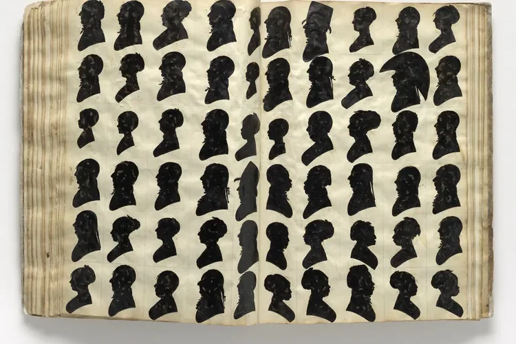Silhouette profiles of women with hairstyles, arranged in rows on aged pages of an open book or album.