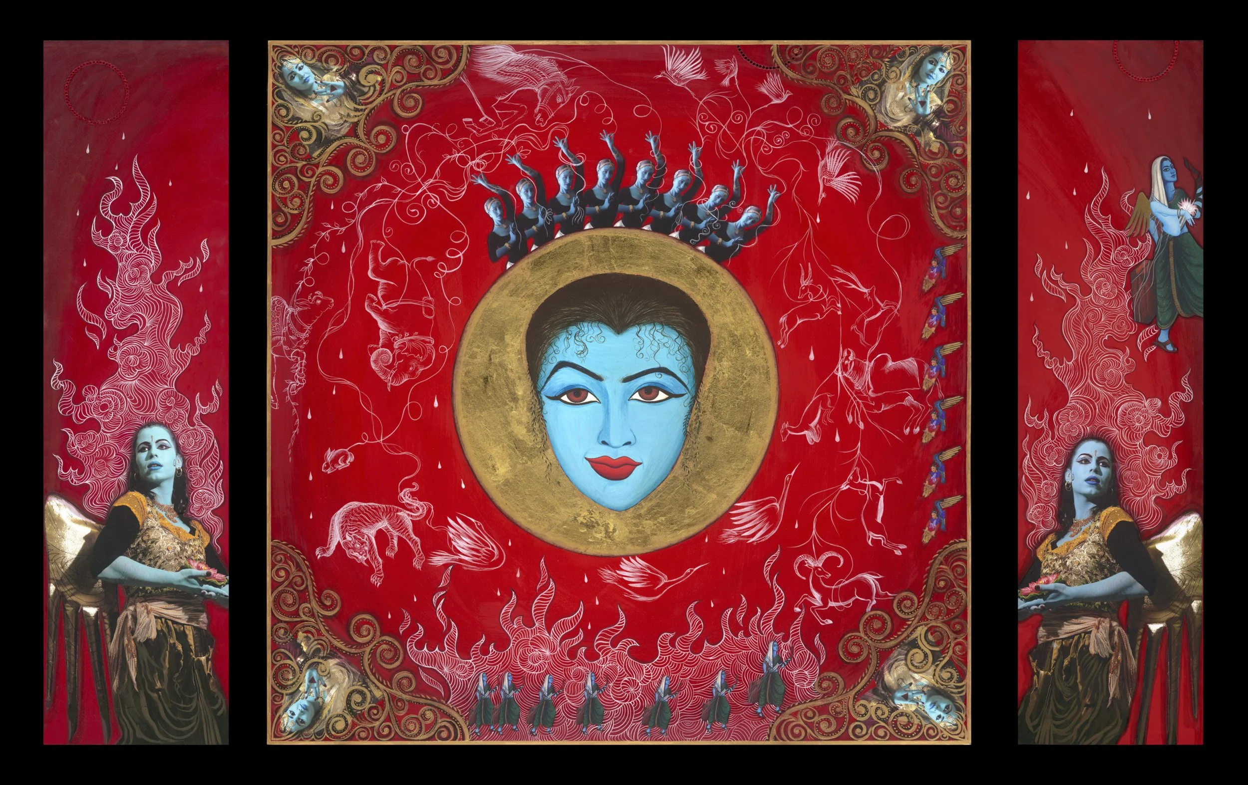 Colorful artwork featuring a central blue goddess face with a golden halo, surrounded by red background with white decorative patterns, dancers, and mythical creatures, flanked by two women with blue faces and elegant attire.