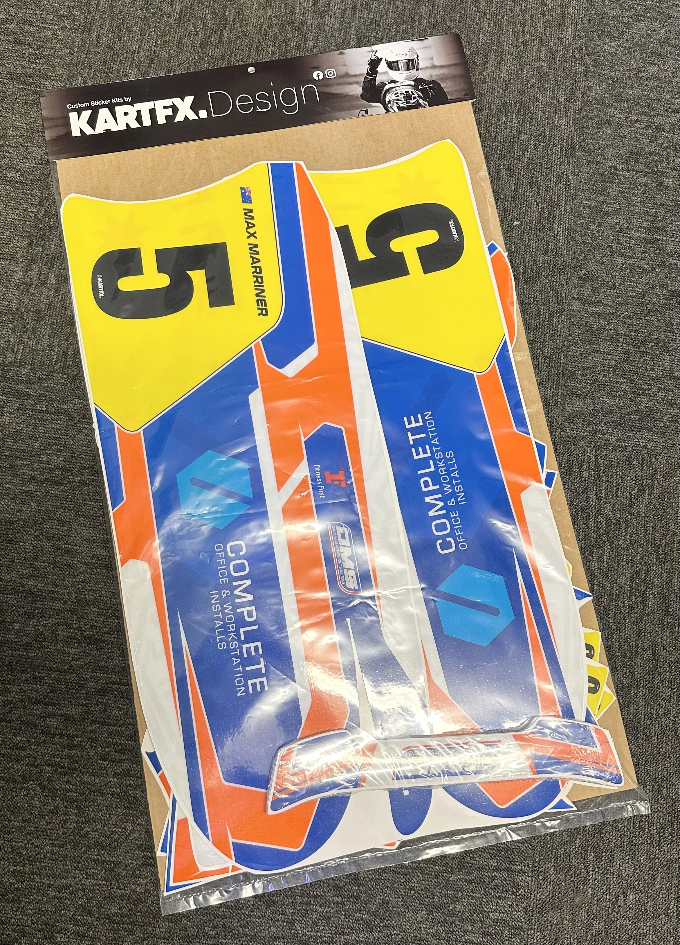 Colorful decal stickers for race cars, with numbers 5 and 3, and labels like 'Max Mariner' and 'Complete Office & Workshop Installations'.