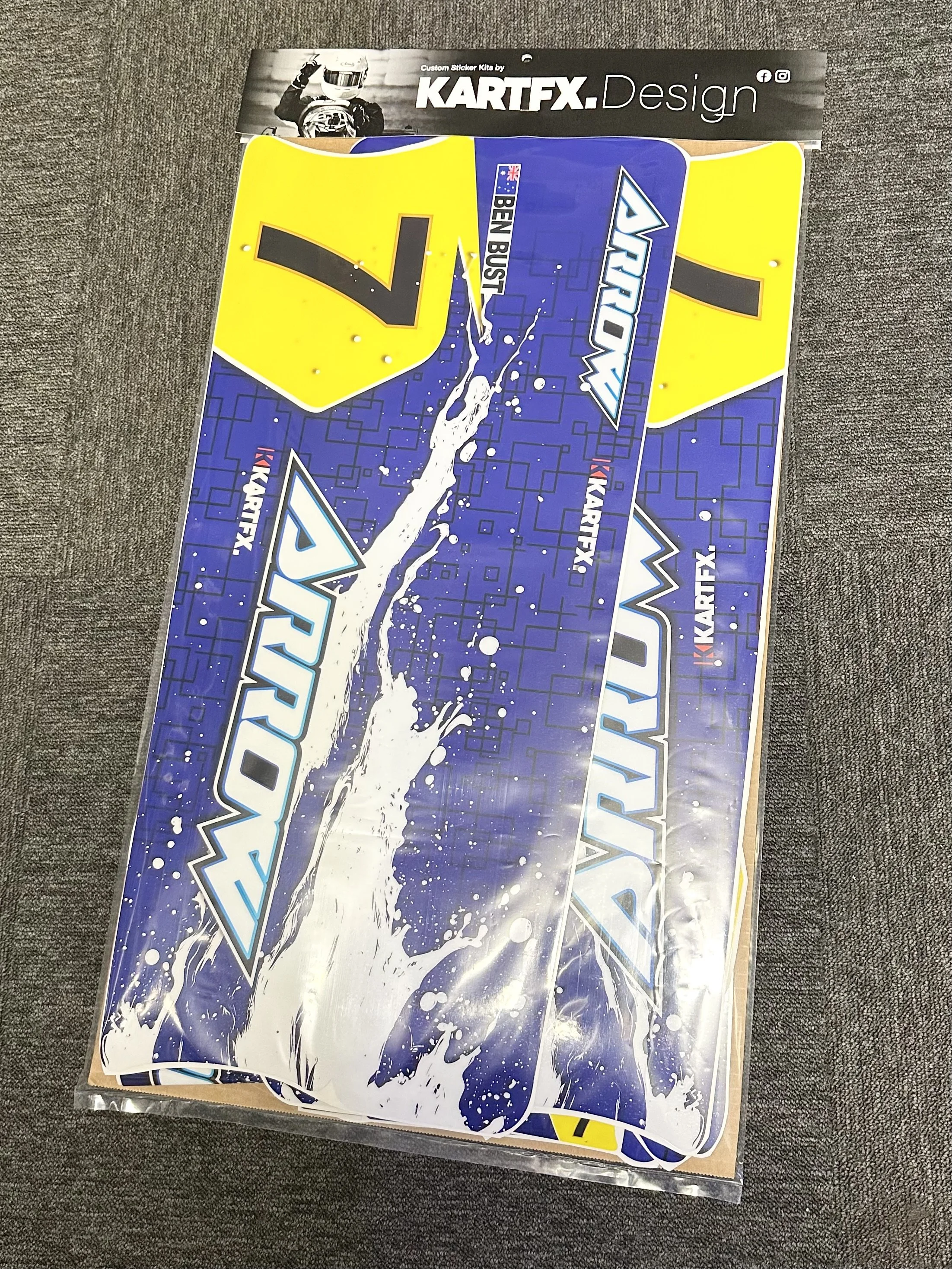 Various race car decals with blue, yellow, and white colors, including the words 'JORDAN' and 'Ben BUST' on a blue background with water splash graphics.