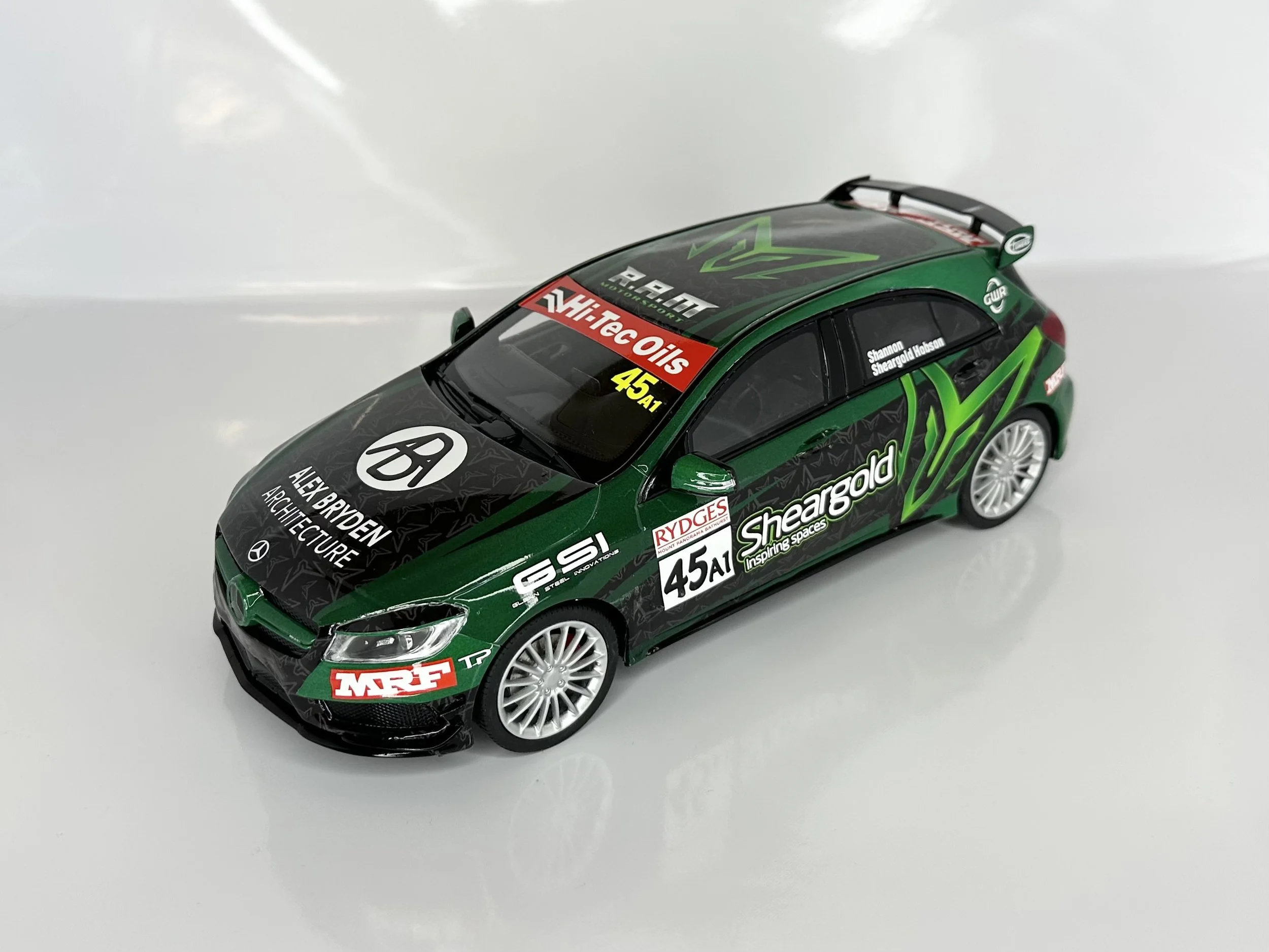 Model race car with green and black livery, various sponsor logos, and racing number 45A1.