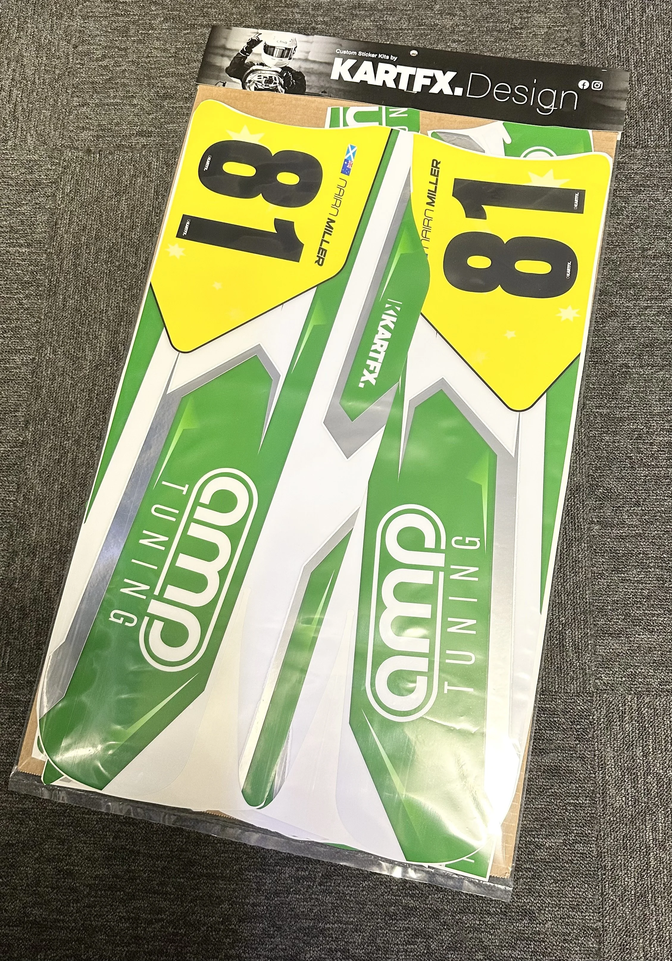 Set of green and white racing stickers with the word "GRIP" on them, and two yellow stickers with the number 8 and 11, along with the name "HARRA MILLER." Additionally, there is a black and white sticker at the top with the text "KARTFX.Design.".